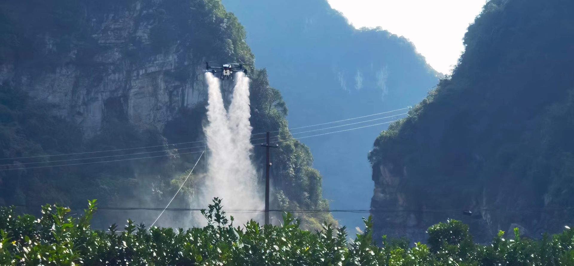 A drone is flying through the air in the woods.