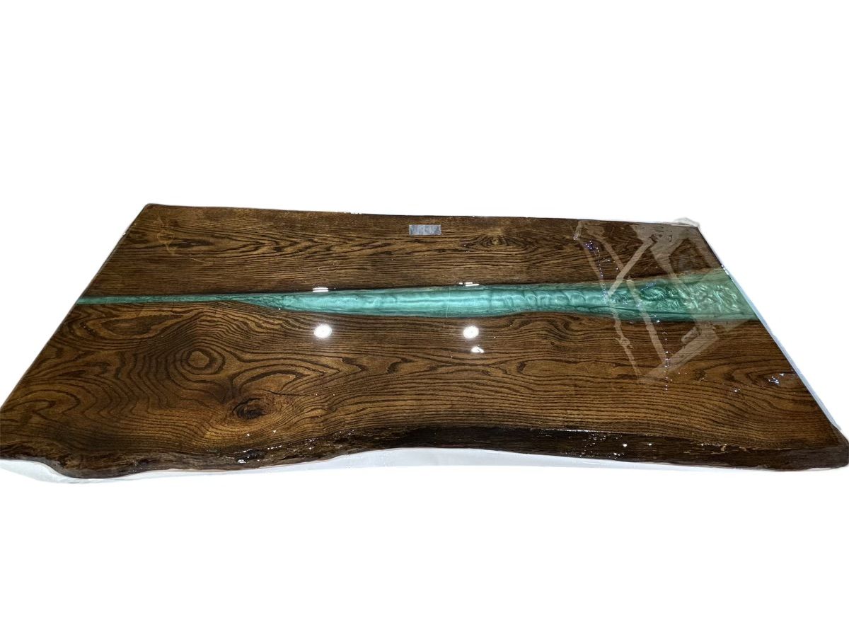 A live edge wooden table with a custom epoxy inlay on a white background.