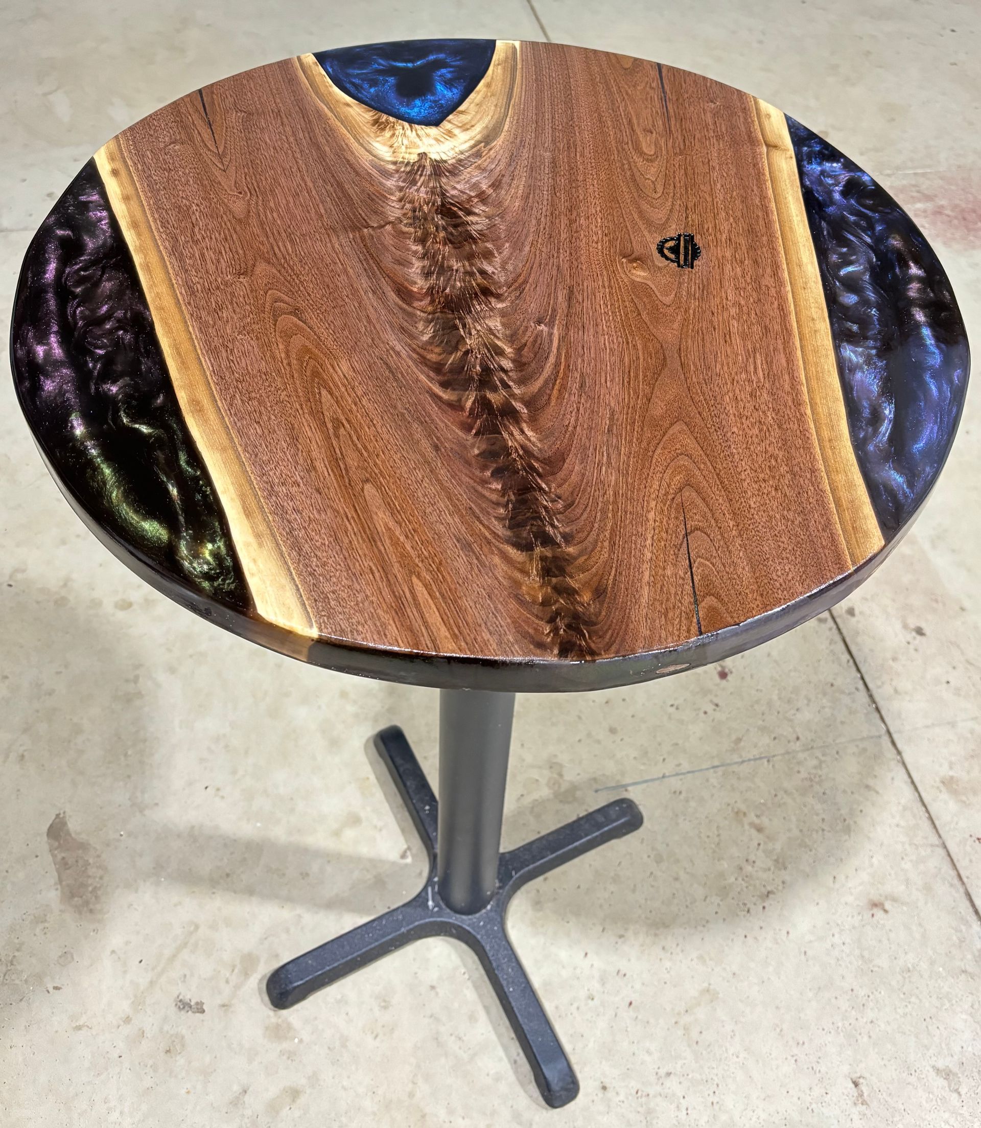 A round table with a wooden top and a metal base