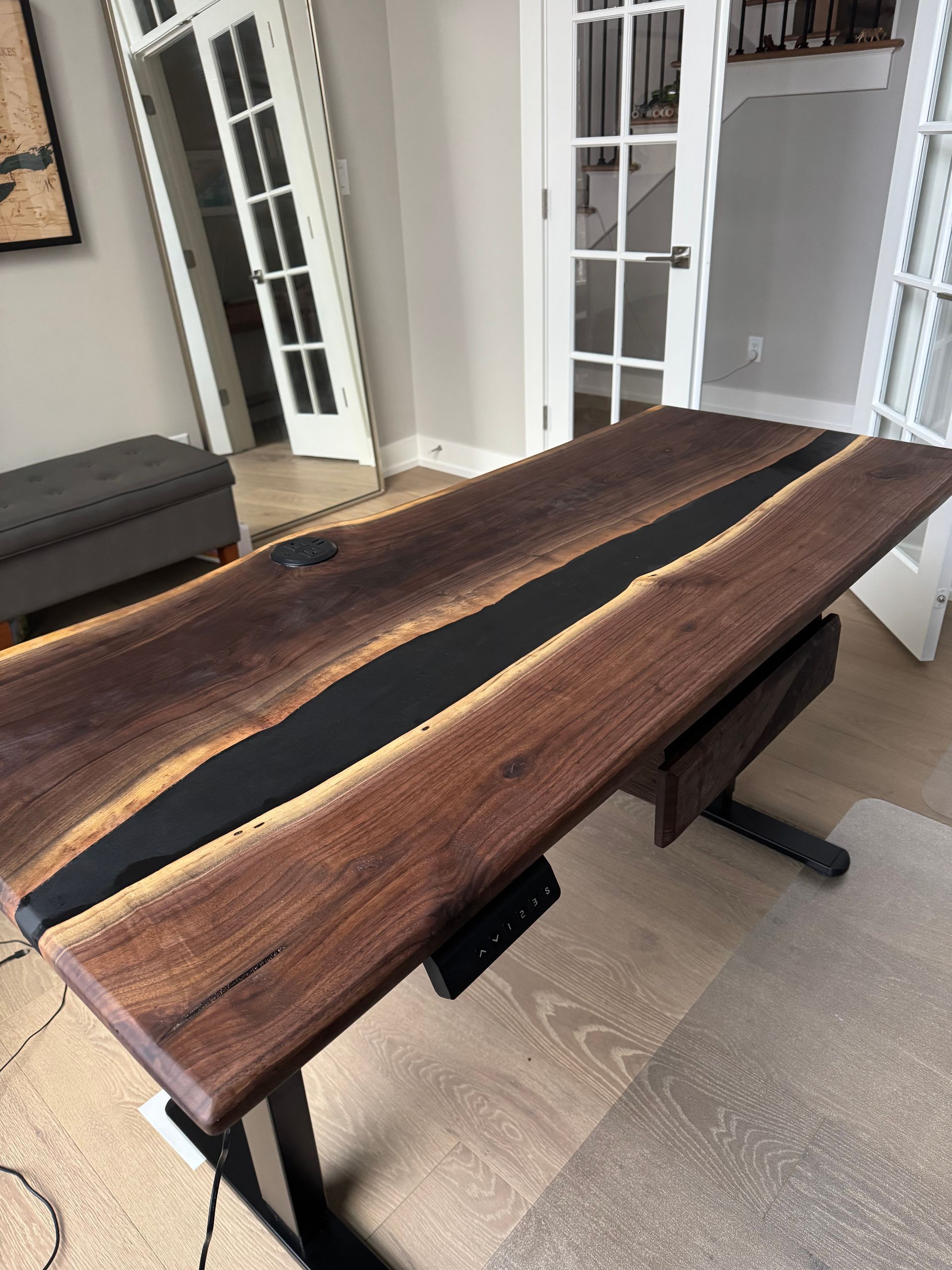 A wooden table with a custom epoxy inlay on a white background.
