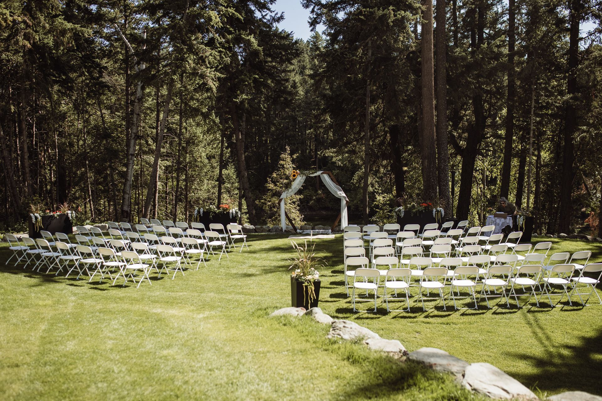 A wedding ceremony is taking place in the middle of a forest