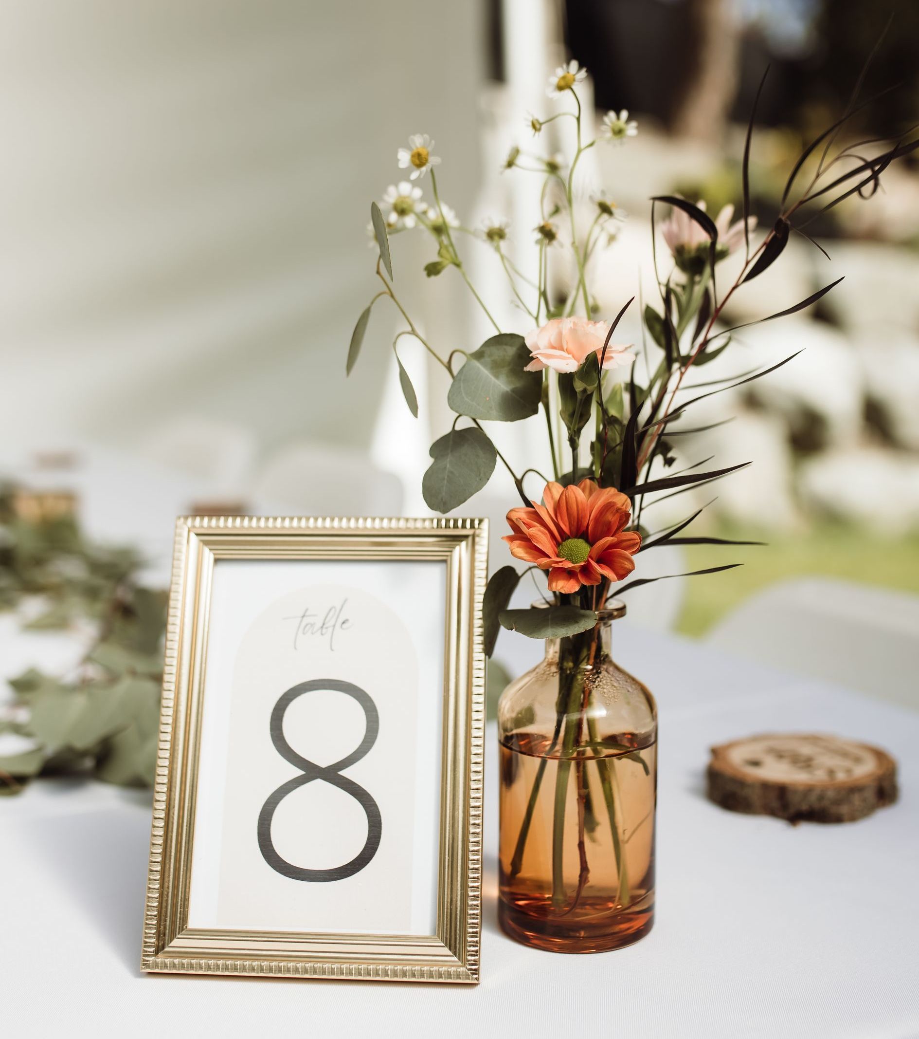 A table with a vase of flowers and a table number.