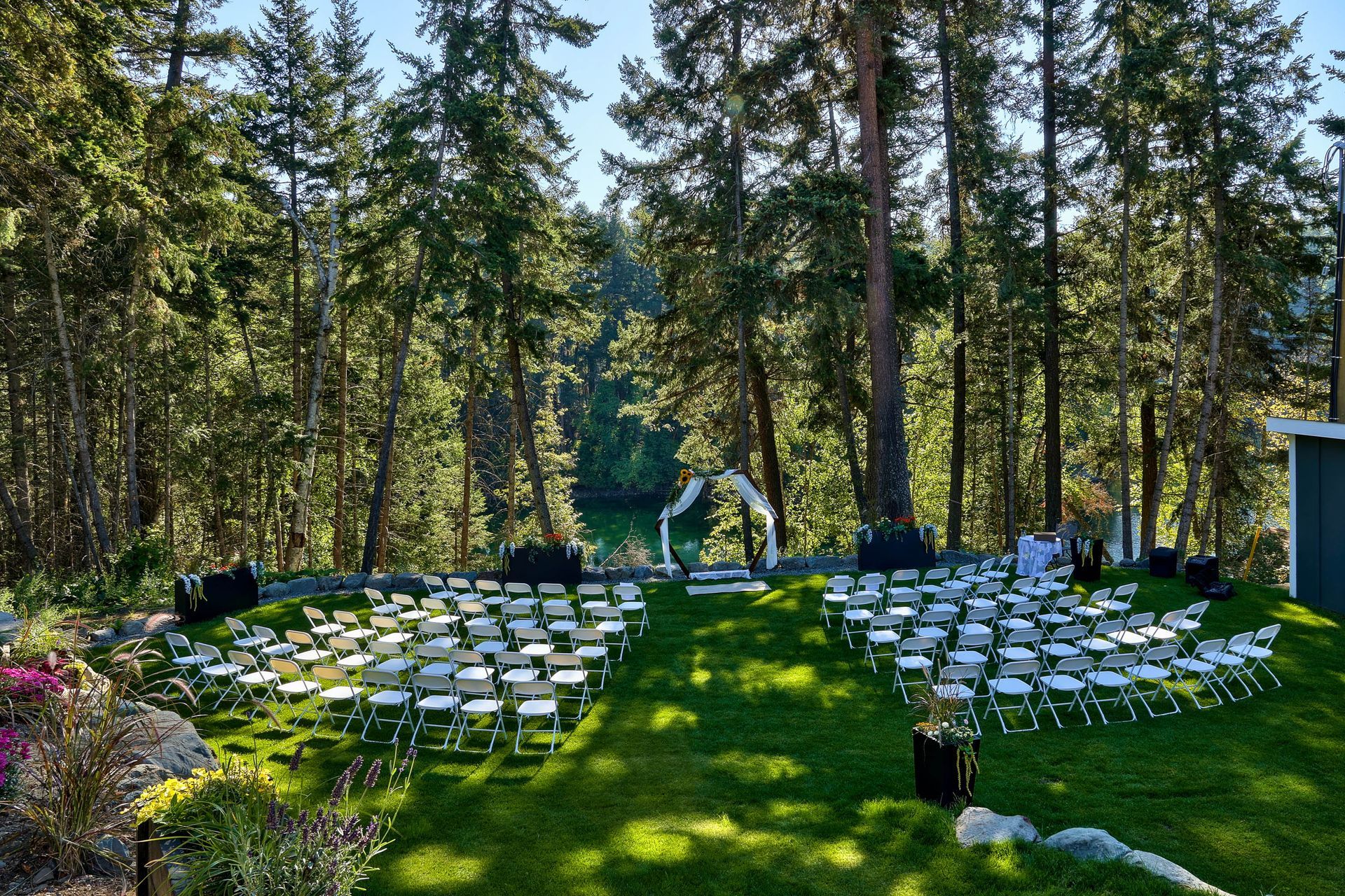A wedding ceremony is taking place in the middle of a forest.