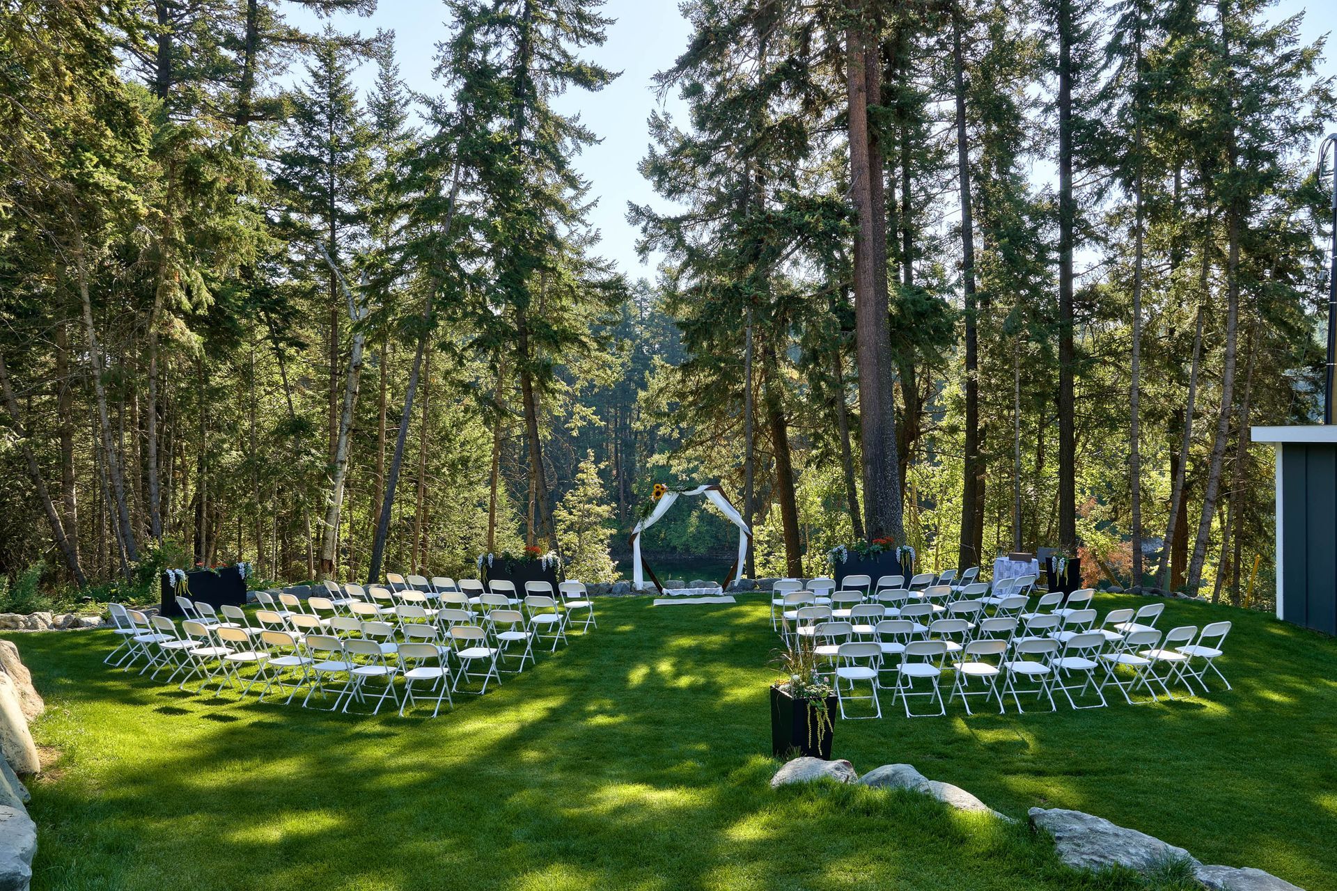 A wedding ceremony is taking place in the middle of a forest.