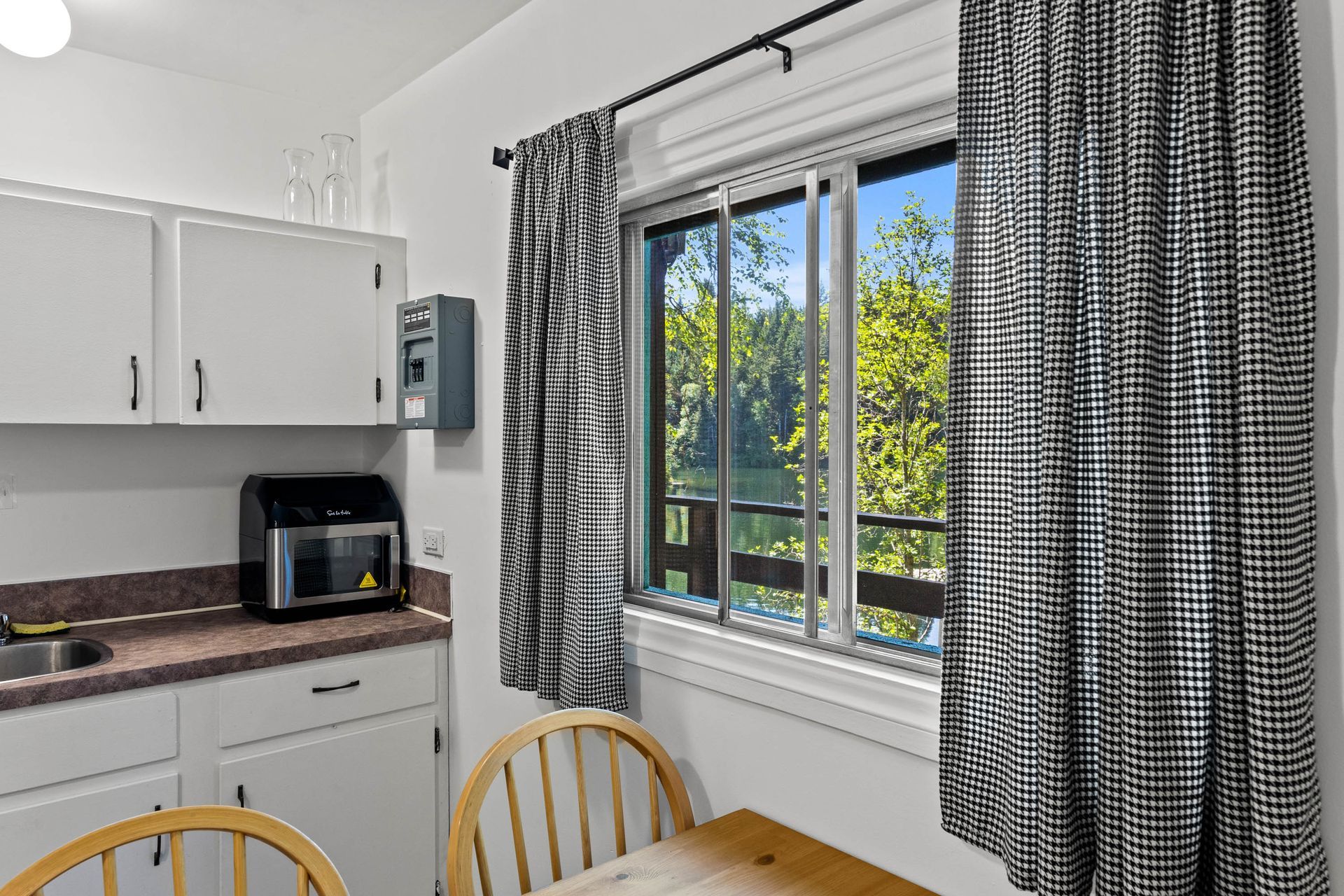 A kitchen with a table and chairs and a window
