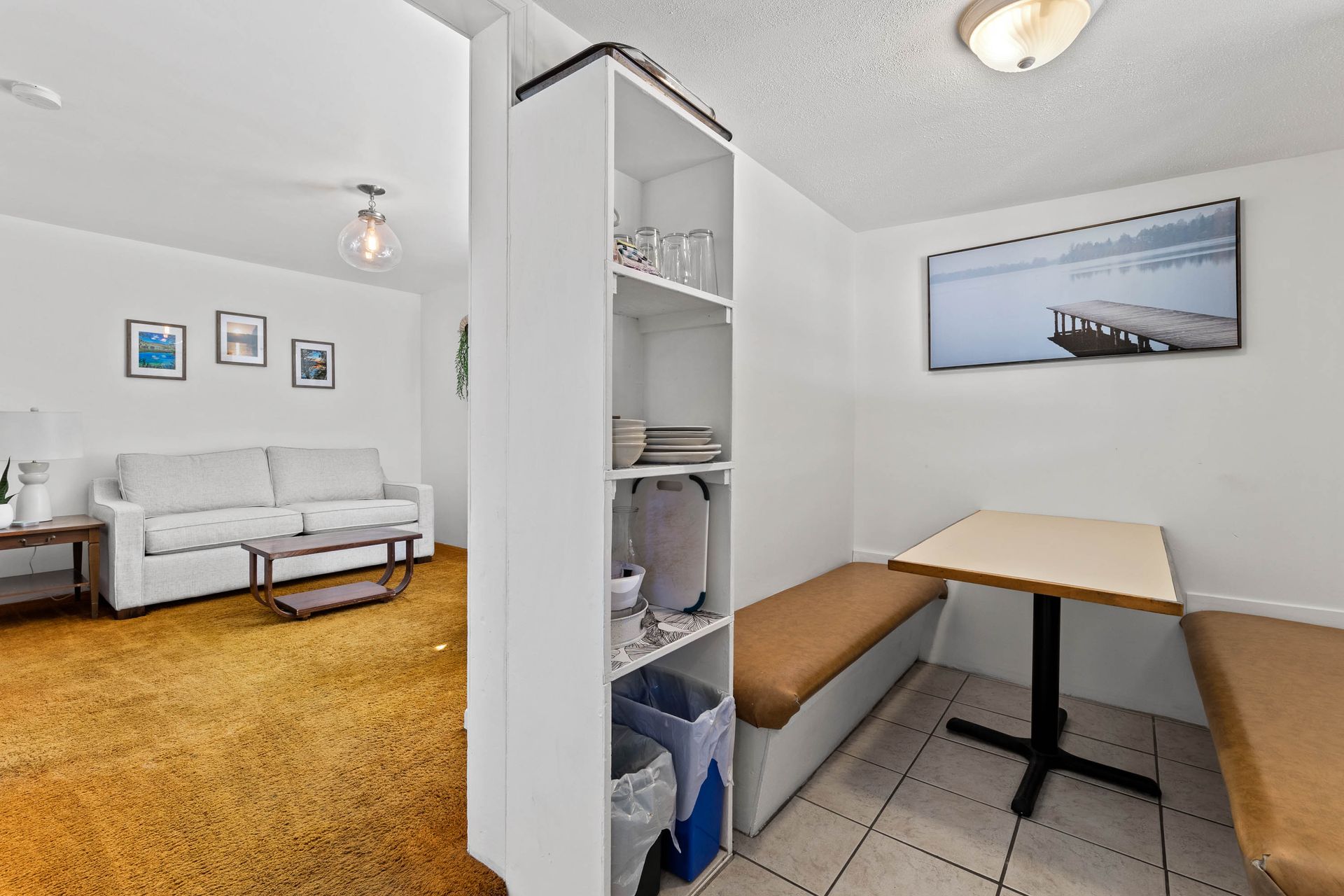 A living room with a couch , table and bench.