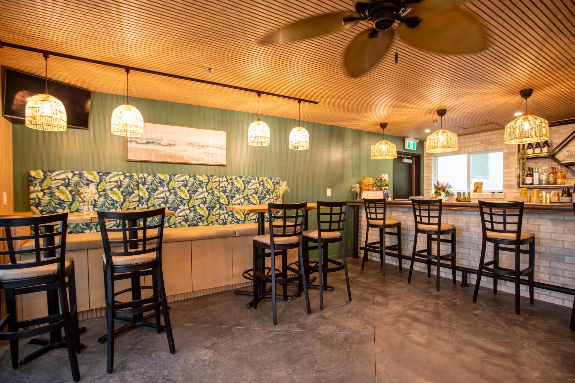A restaurant with tables and chairs and a ceiling fan.