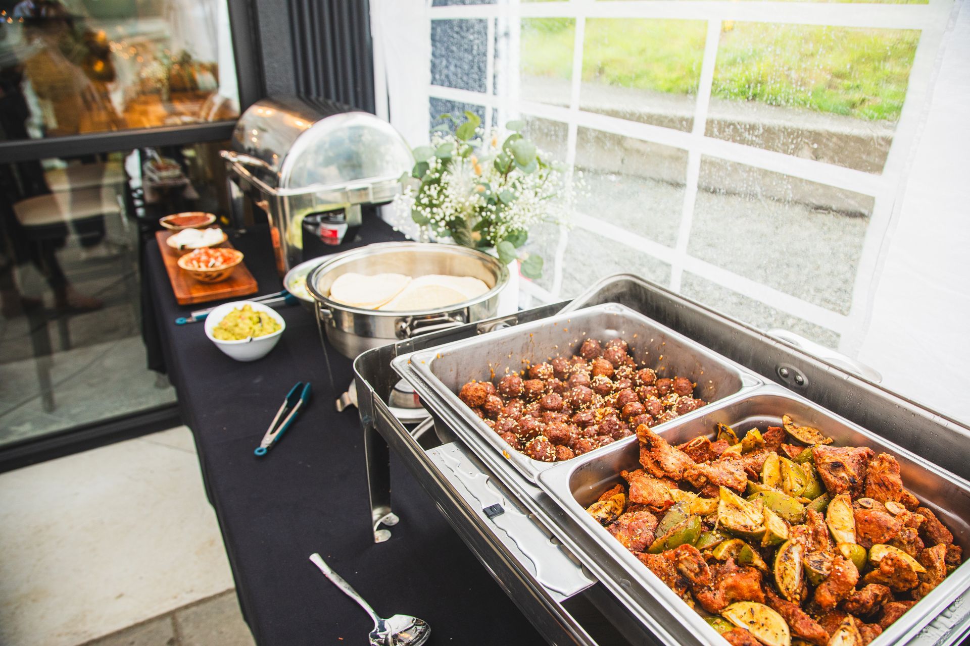 A buffet table with a variety of food on it.