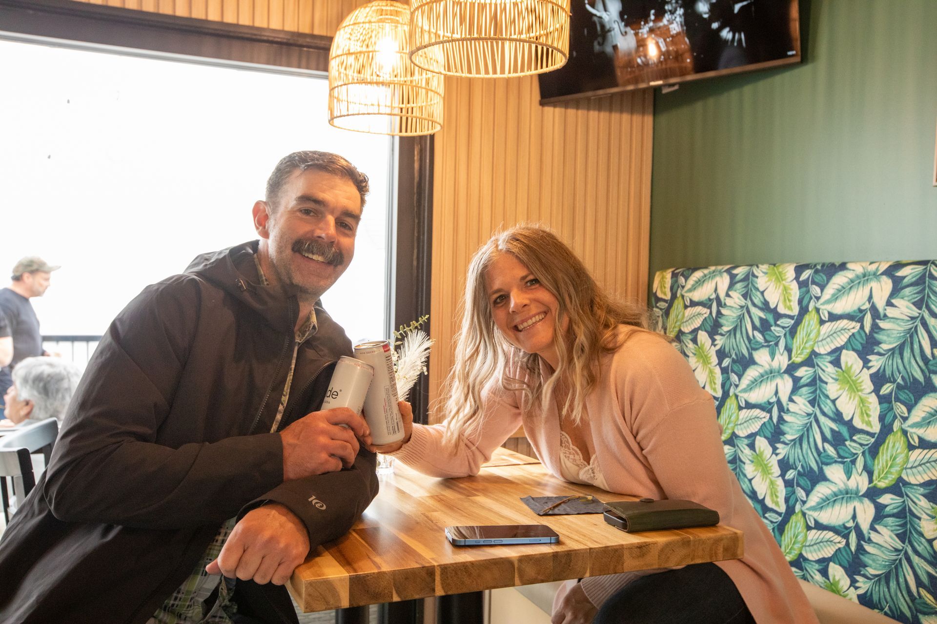 A man and a woman are sitting at a table in a restaurant.