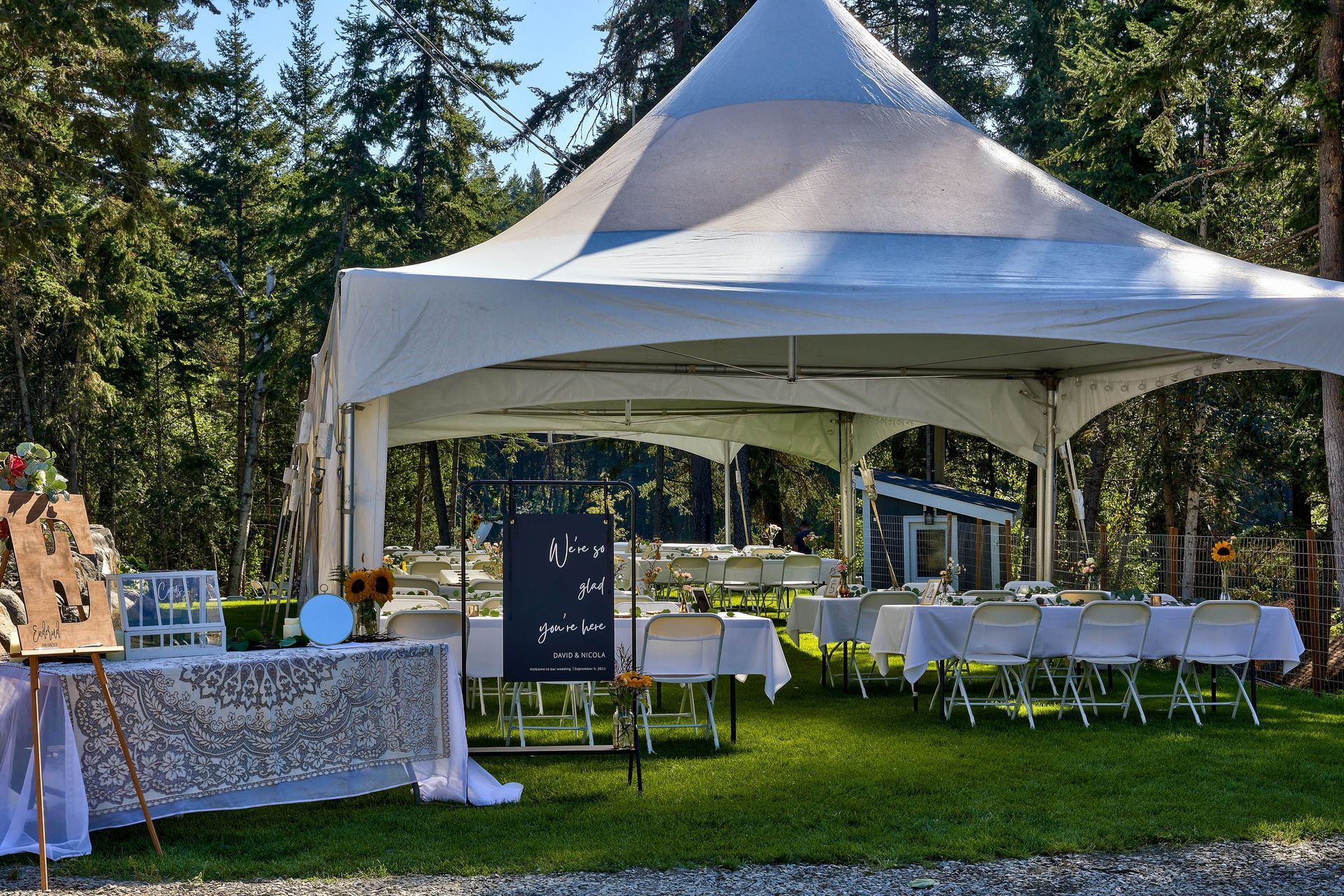 A white tent with tables and chairs underneath it