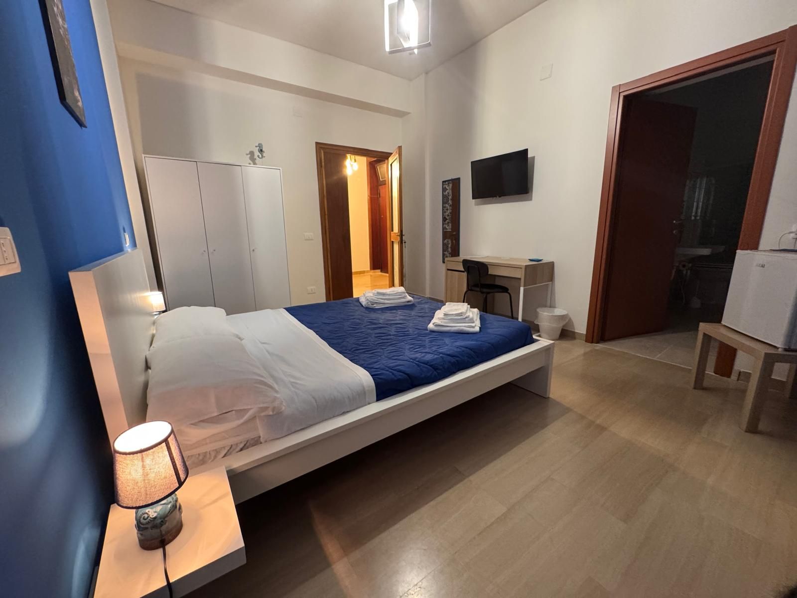 Una camera da letto con un letto grande e una televisione sulla parete.