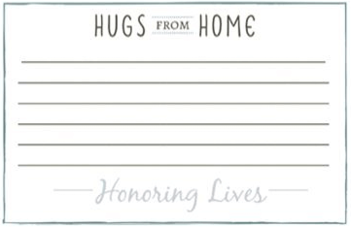 A piece of paper with the words `` hugs from home honoring lives '' written on it.