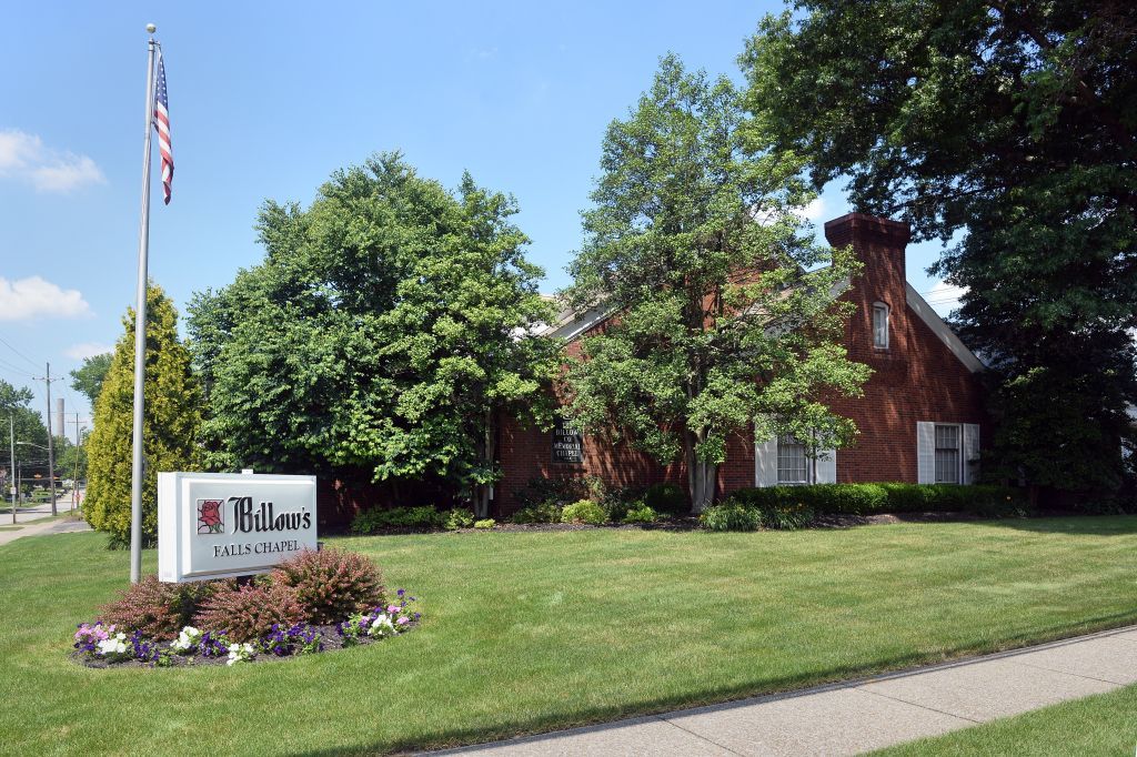 A brick building with a sign in front of it that says titan