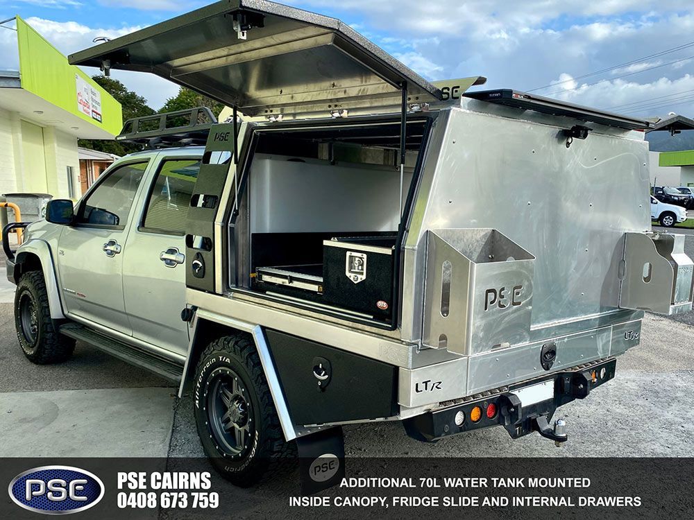 A Silver Truck with A Canopy on Top of It Is Parked in A Parking Lot — PSE Stainless Steel Fabrications in Manunda, QLD