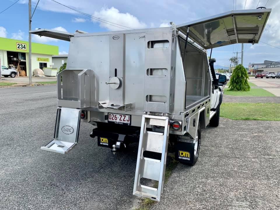 A silver truck with a ladder attached to the back is parked on the side of the road  — PSE Stainless Steel Fabrications in Manunda, QLD