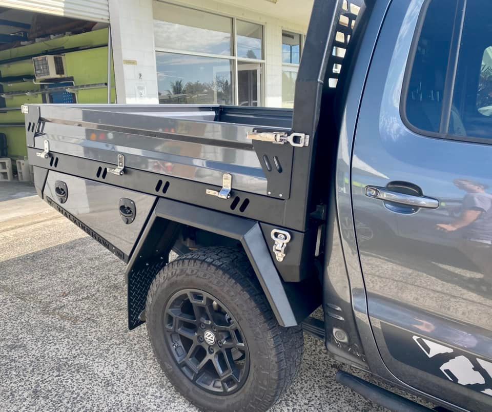 A Gray Truck with A Tray on The Back Is Parked in Front of A Building — PSE Stainless Steel Fabrications in Manunda, QLD