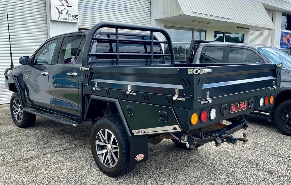 A Truck with A Trailer Attached to It Is Parked in Front of A Building — PSE Stainless Steel Fabrications in Manunda, QLD