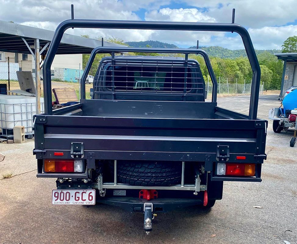 A black truck with a license plate that says 900 gc6  — PSE Stainless Steel Fabrications in Manunda, QLD
