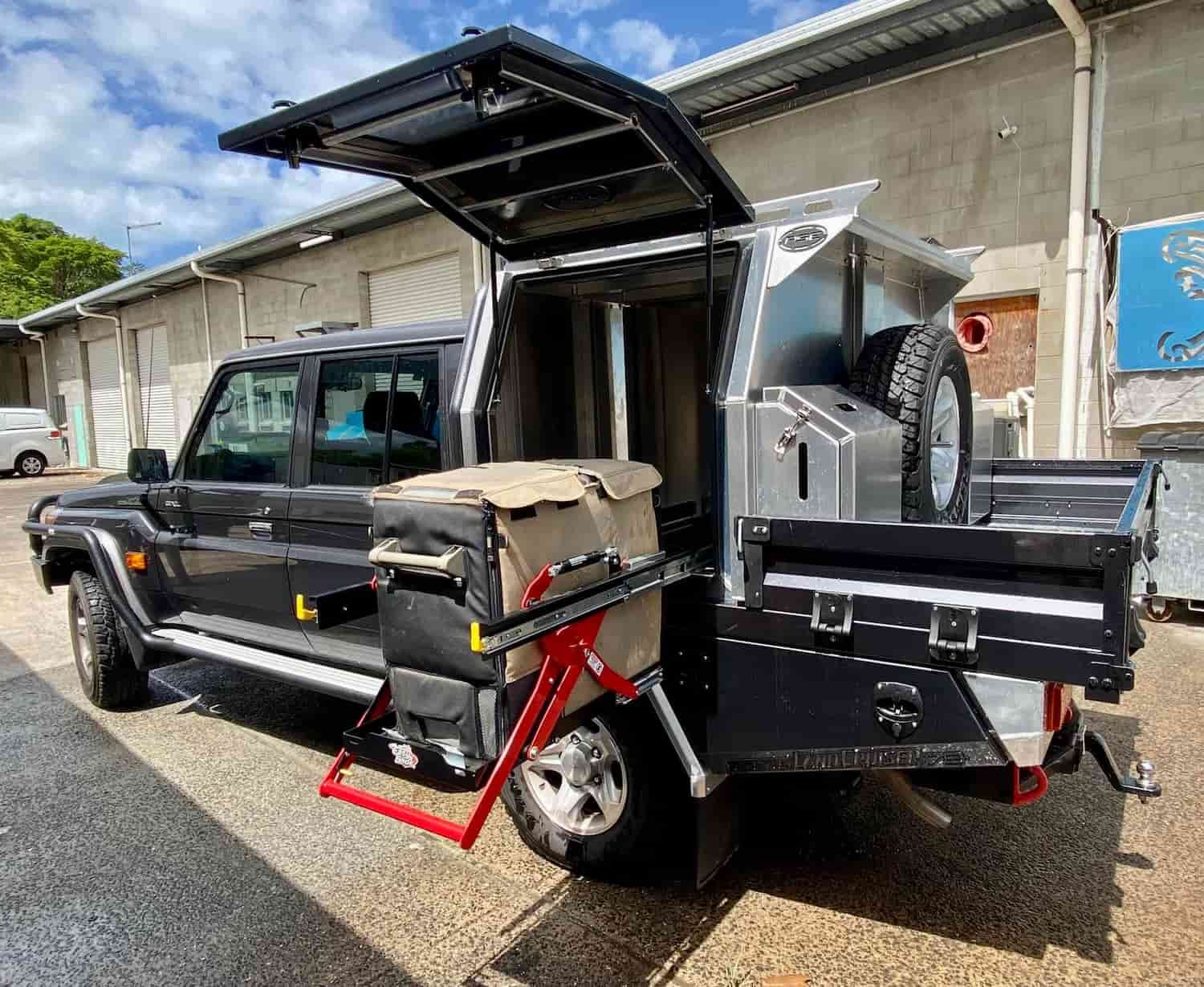 A Truck With Its Trunk Open is Parked in Front of a Building — PSE Stainless Steel Fabrications In Manunda, QLD