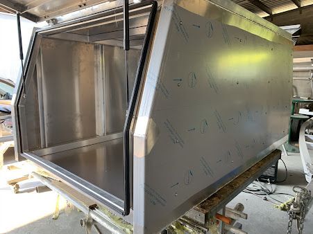 A Stainless Steel Canopy Is Sitting on Top of A Wooden Table — PSE Stainless Steel Fabrications in Manunda, QLD