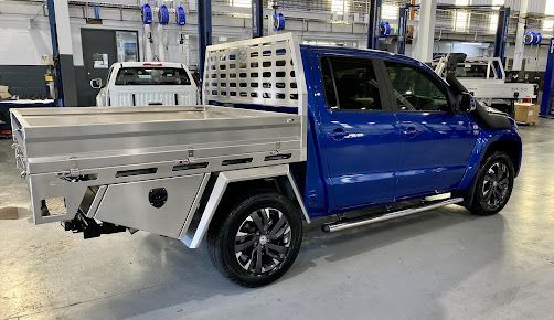 A Blue Truck with A Tray on The Back Is Parked in A Garage — PSE Stainless Steel Fabrications in Manunda, QLD