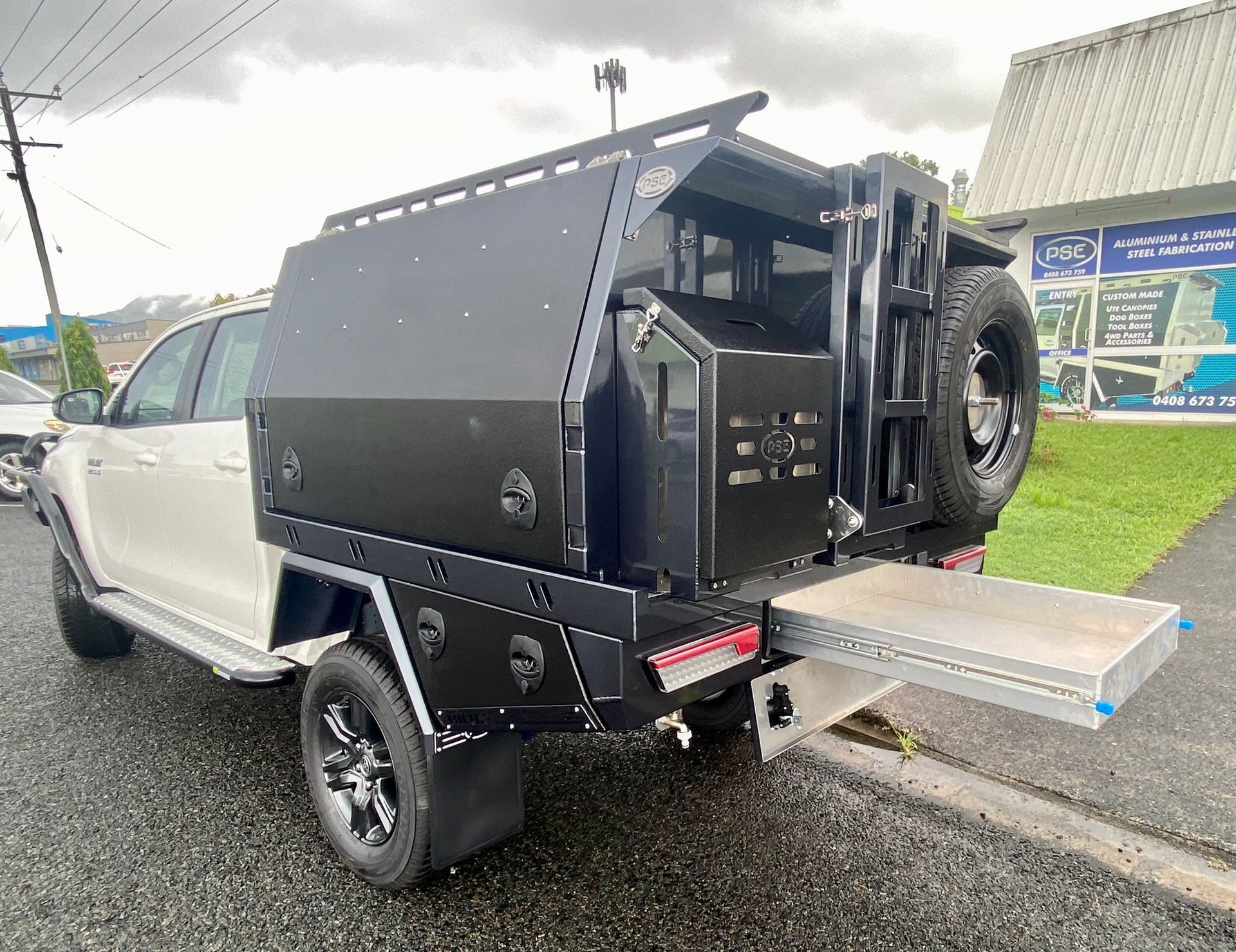 A white truck with a black canopy is parked on the side of the road  — PSE Stainless Steel Fabrications in Manunda, QLD