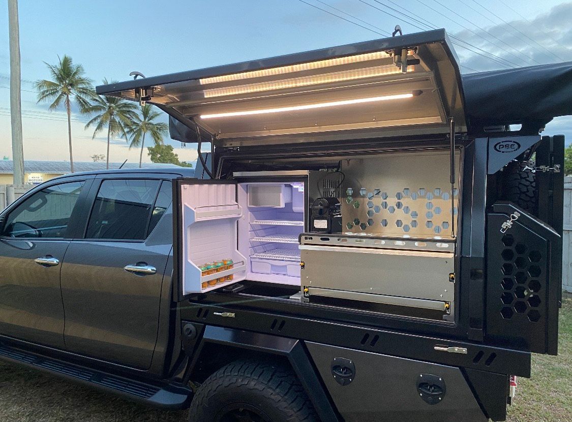A truck with a refrigerator in the back of it  — PSE Stainless Steel Fabrications in Manunda, QLD