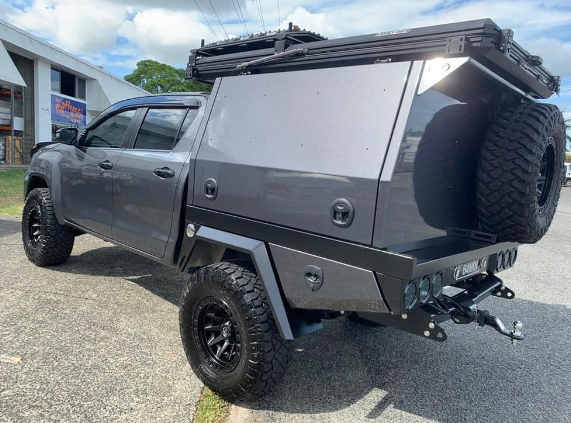 A gray truck with a canopy on top of it is parked on the side of the road — PSE Stainless Steel Fabrications in Manunda, QLD