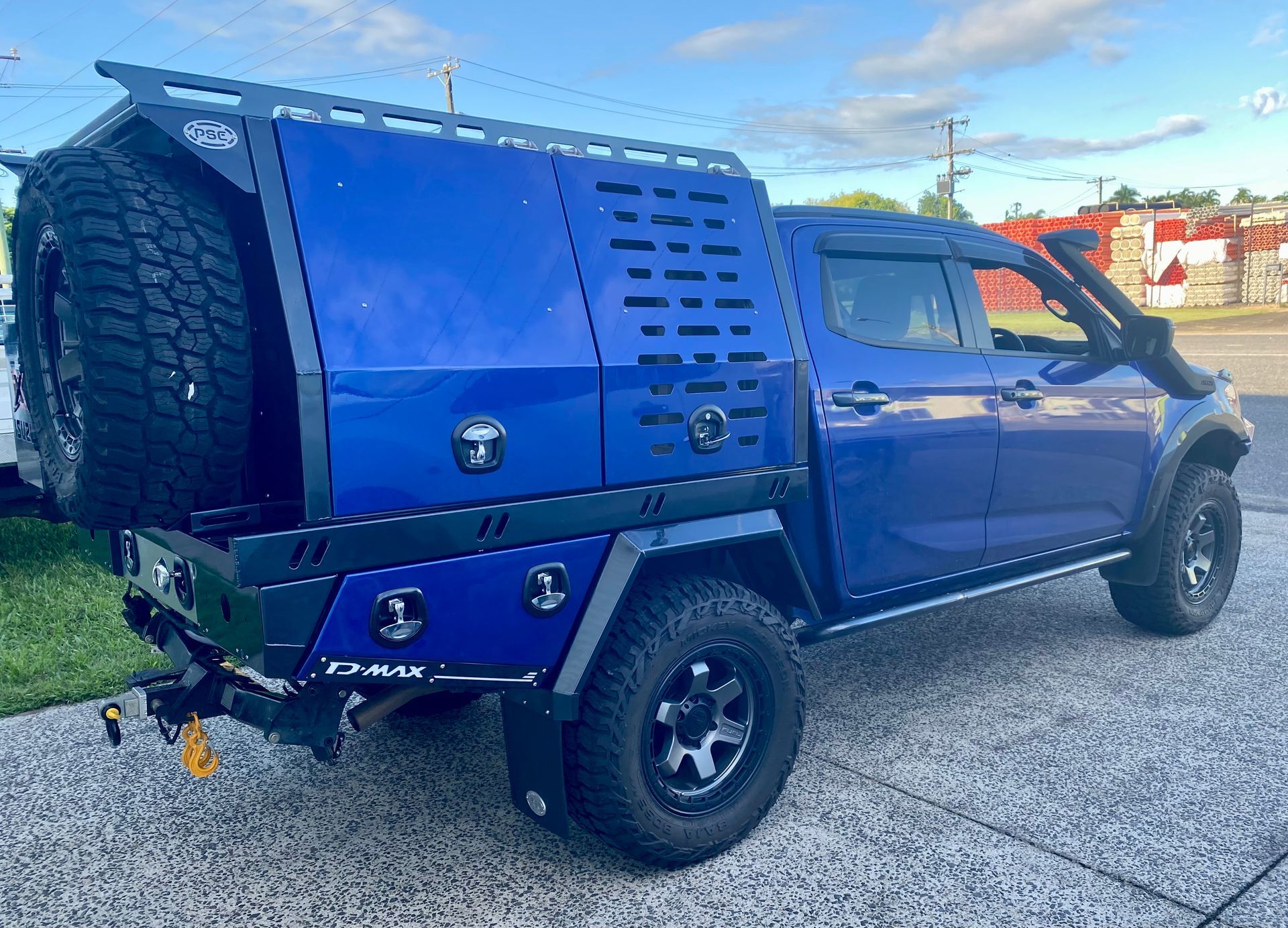 A blue truck with a canopy on top of it is parked on the side of the road  — PSE Stainless Steel Fabrications in Manunda, QLD