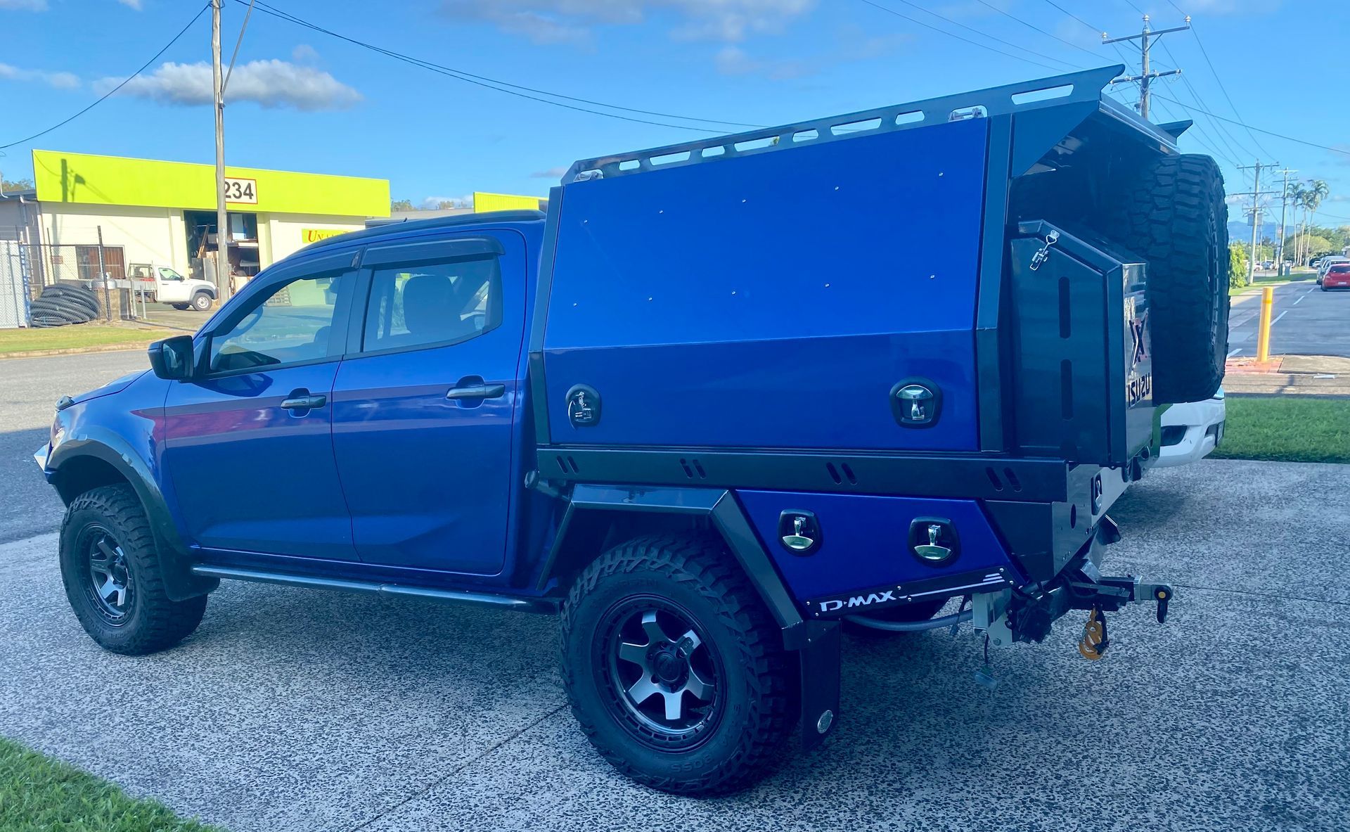 A blue truck with a canopy is parked in a gravel lot  — PSE Stainless Steel Fabrications in Manunda, QLD