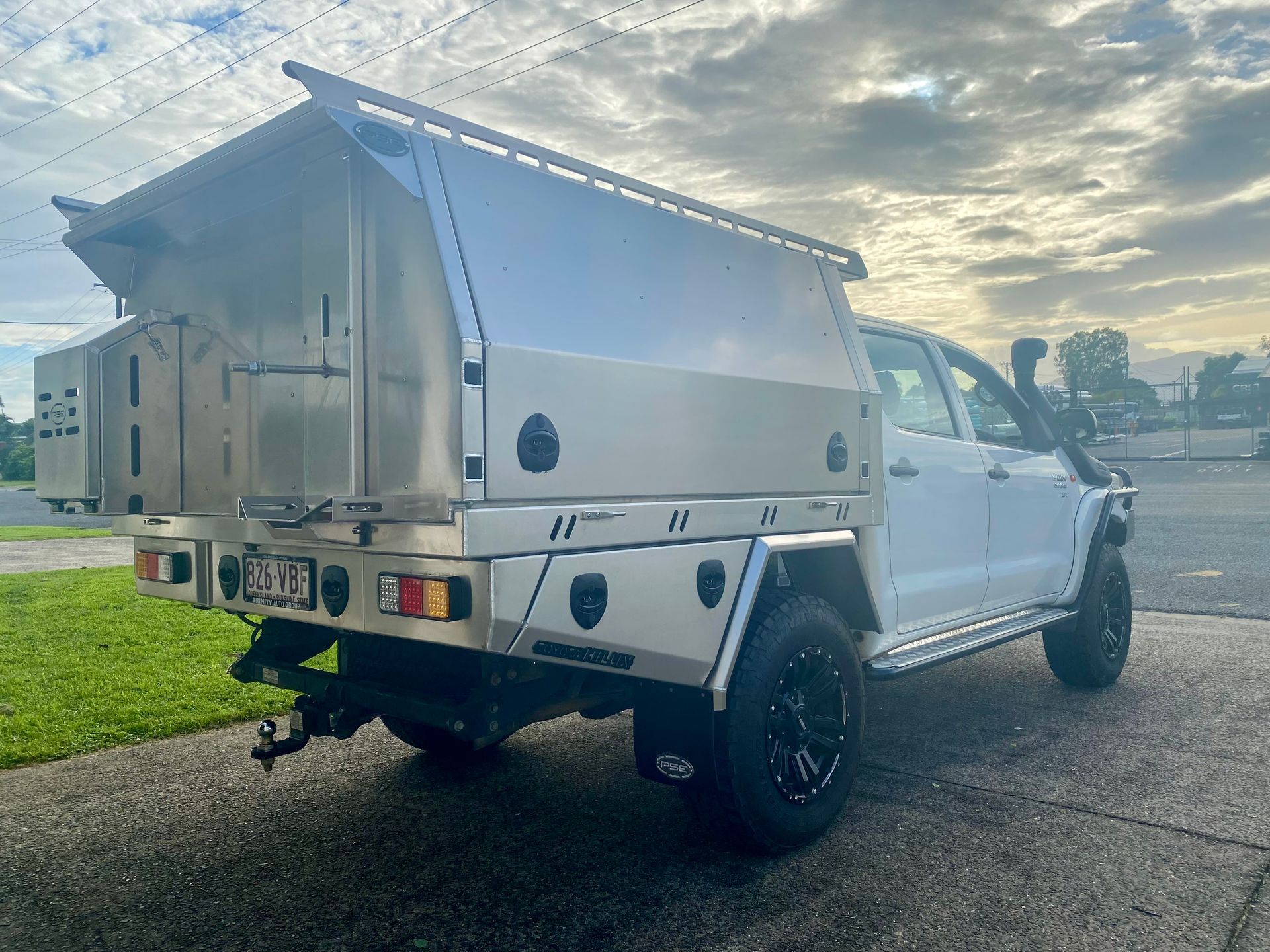 A white truck with a canopy is parked on the side of the road  — PSE Stainless Steel Fabrications in Manunda, QLD
