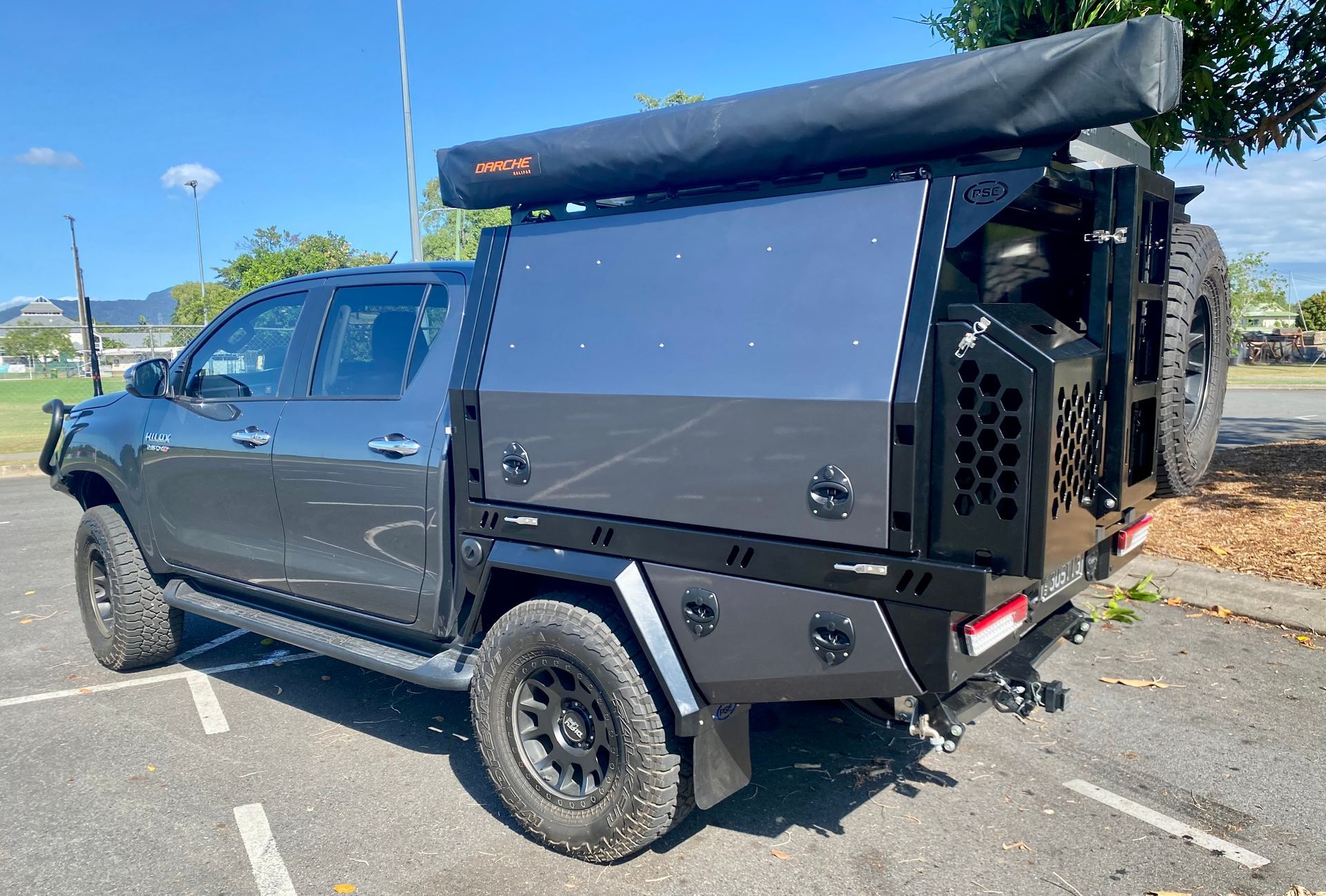 A truck with a canopy on top of it is parked in a parking lot  — PSE Stainless Steel Fabrications in Manunda, QLD