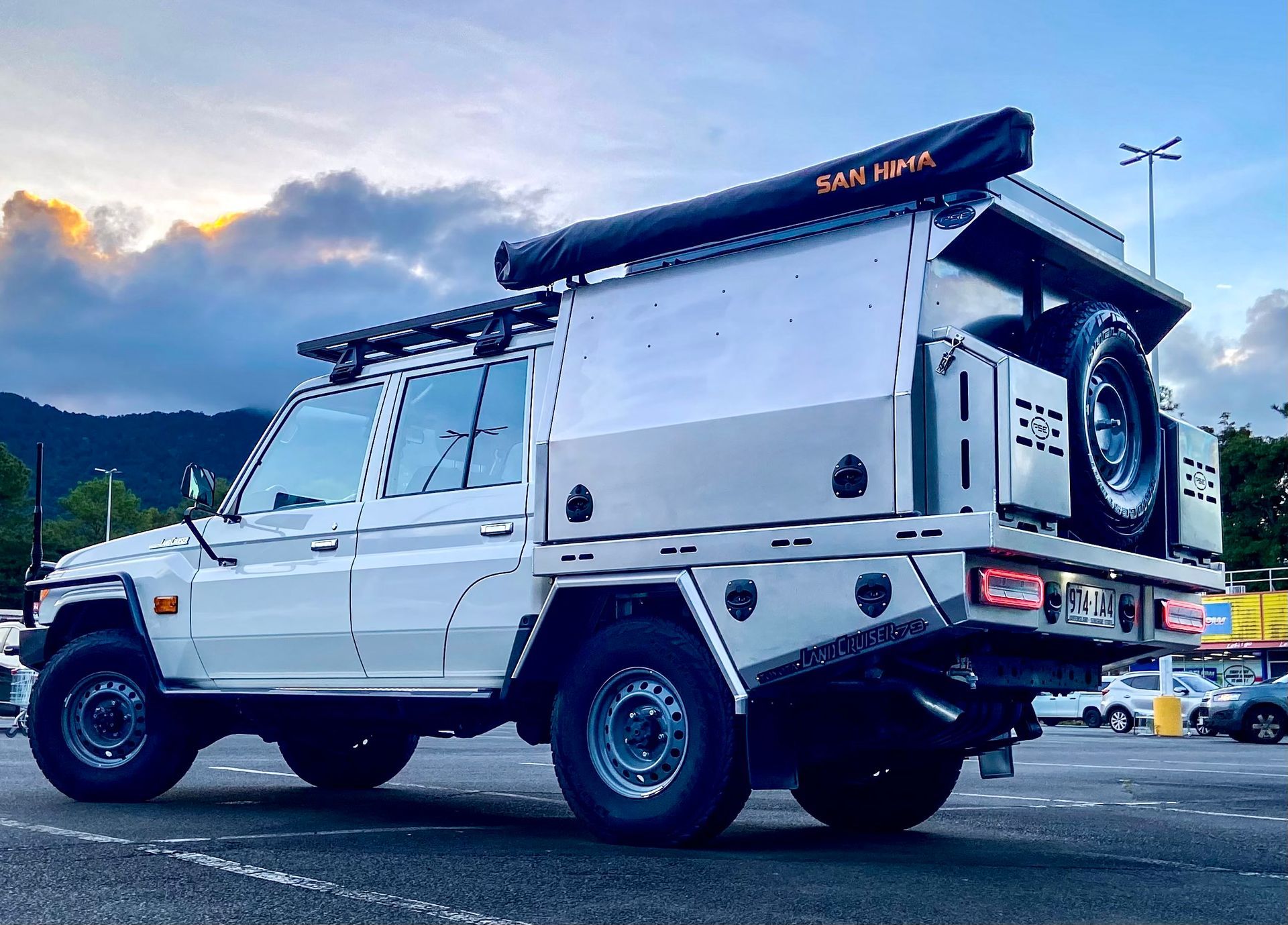 A white truck with a canopy on top of it is parked in a parking lot  — PSE Stainless Steel Fabrications in Manunda, QLD