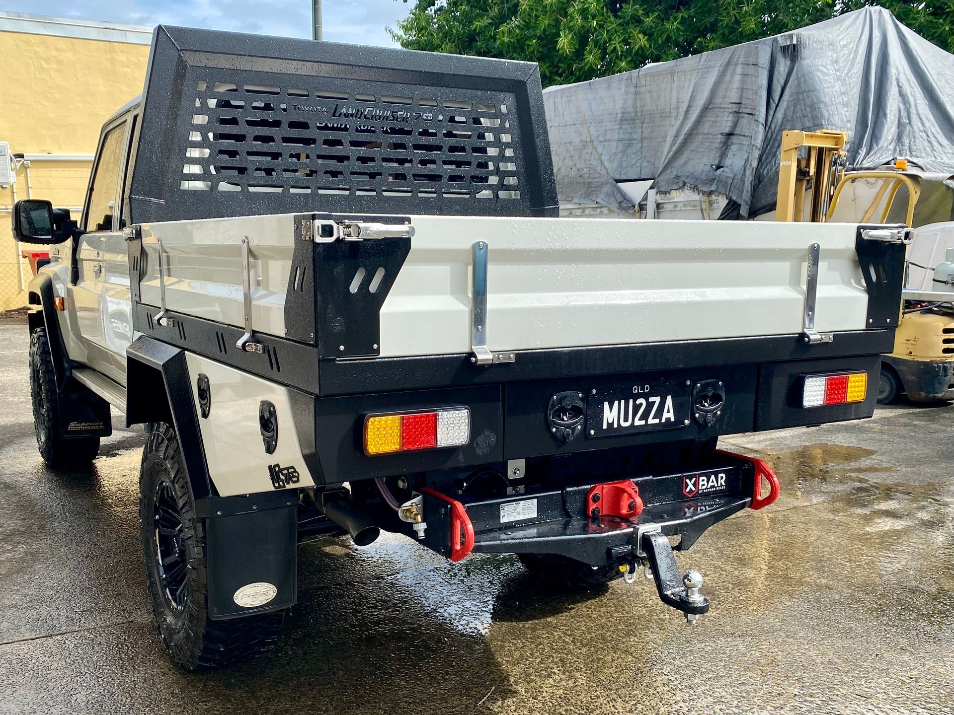 A white truck with a flat bed is parked in a parking lot  — PSE Stainless Steel Fabrications in Manunda, QLD
