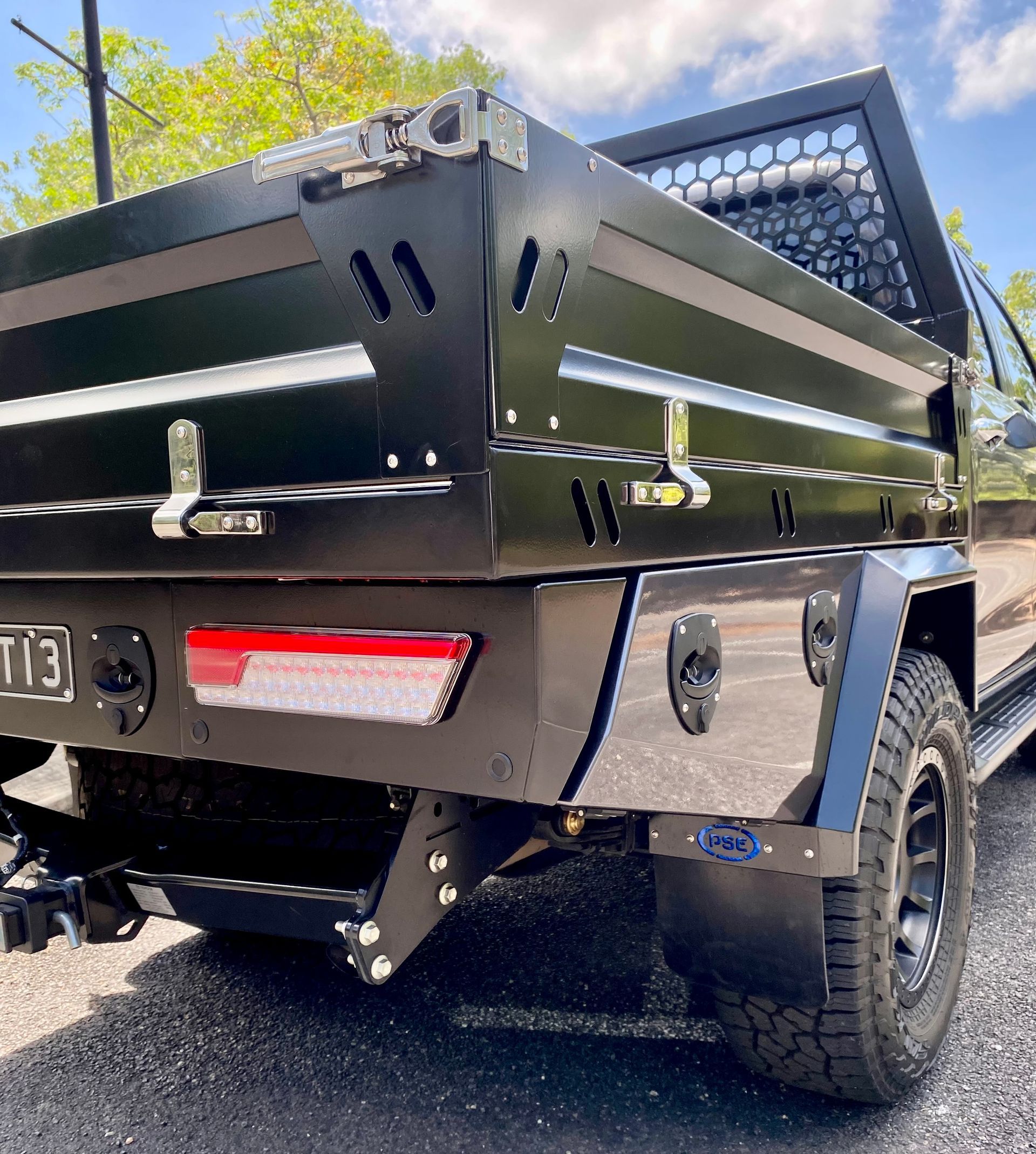 A black truck with a stainless steel bed is parked on the side of the road  — PSE Stainless Steel Fabrications in Manunda, QLD