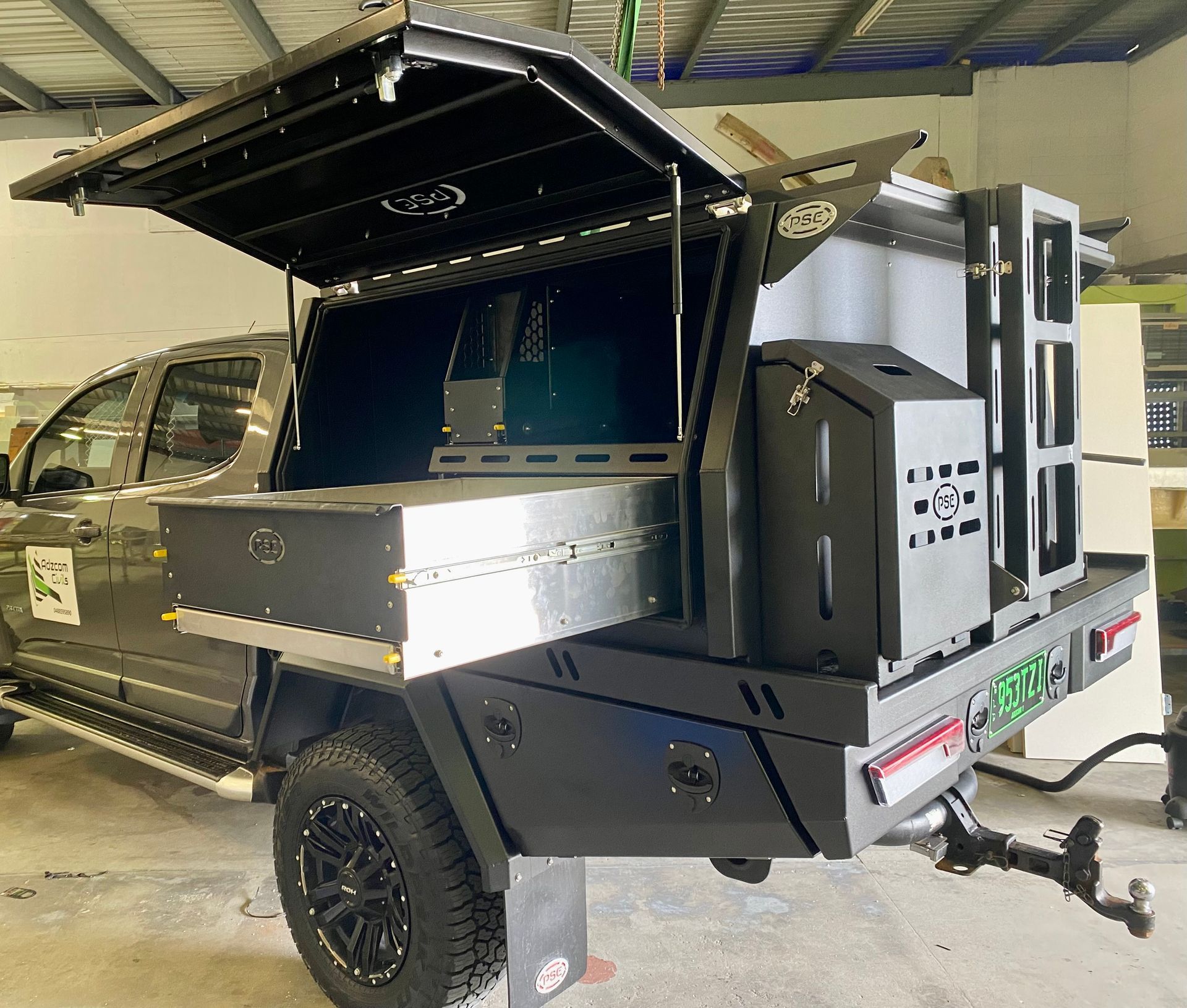 A truck with a canopy on top of it is parked in a garage  — PSE Stainless Steel Fabrications in Manunda, QLD