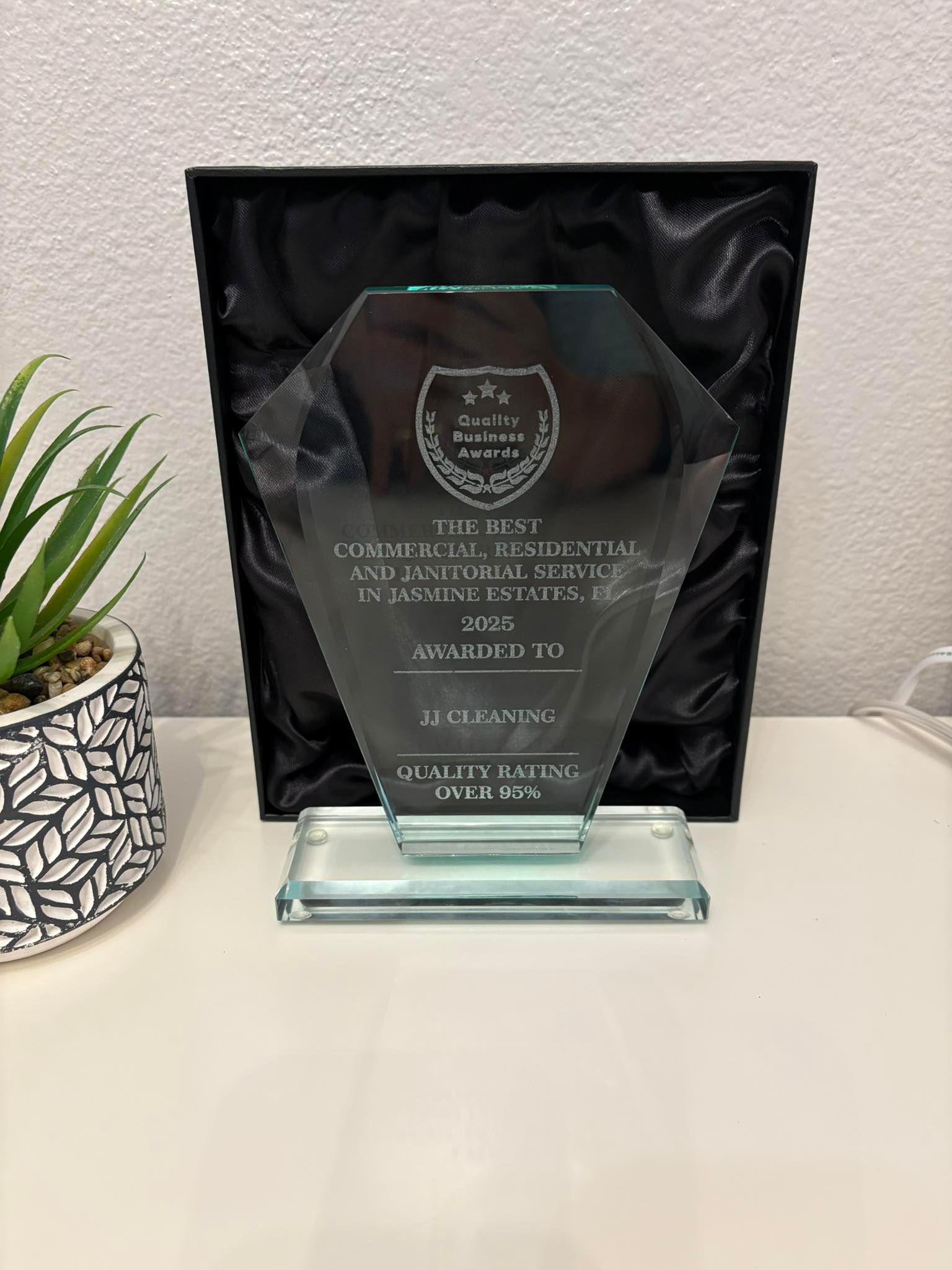 Glass award in black box; text reads 