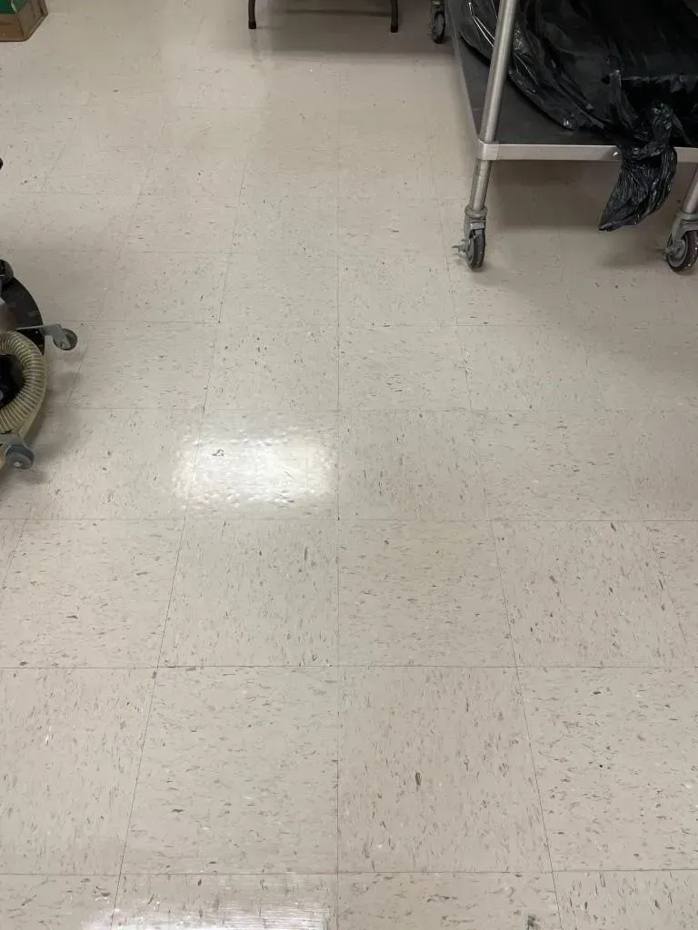 White speckled tile floor with metal medical carts on the sides.