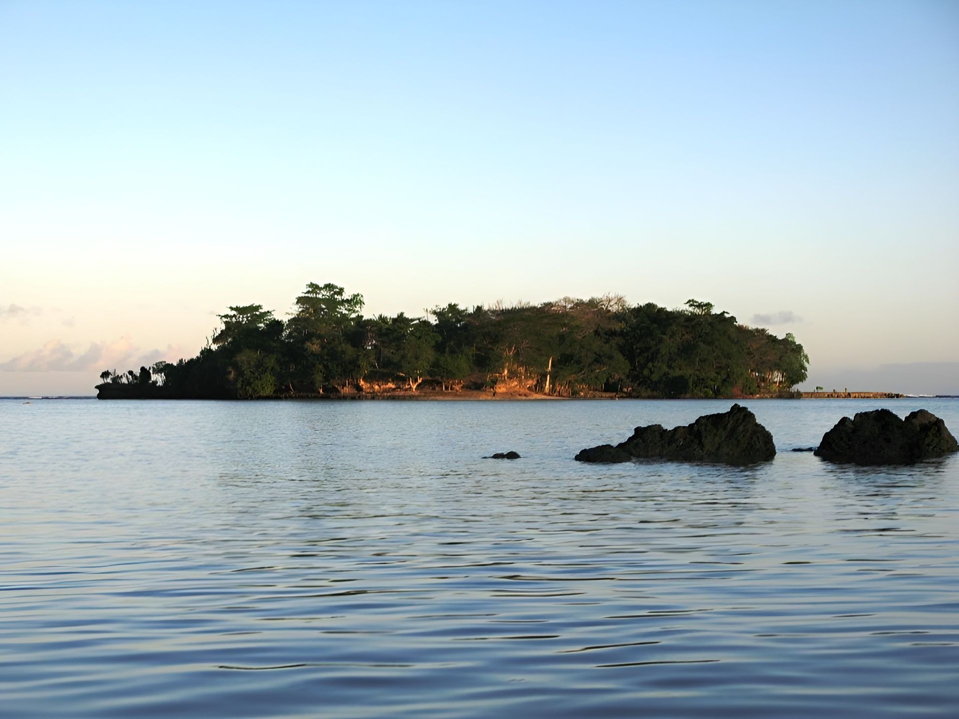 A small island in the middle of a body of water