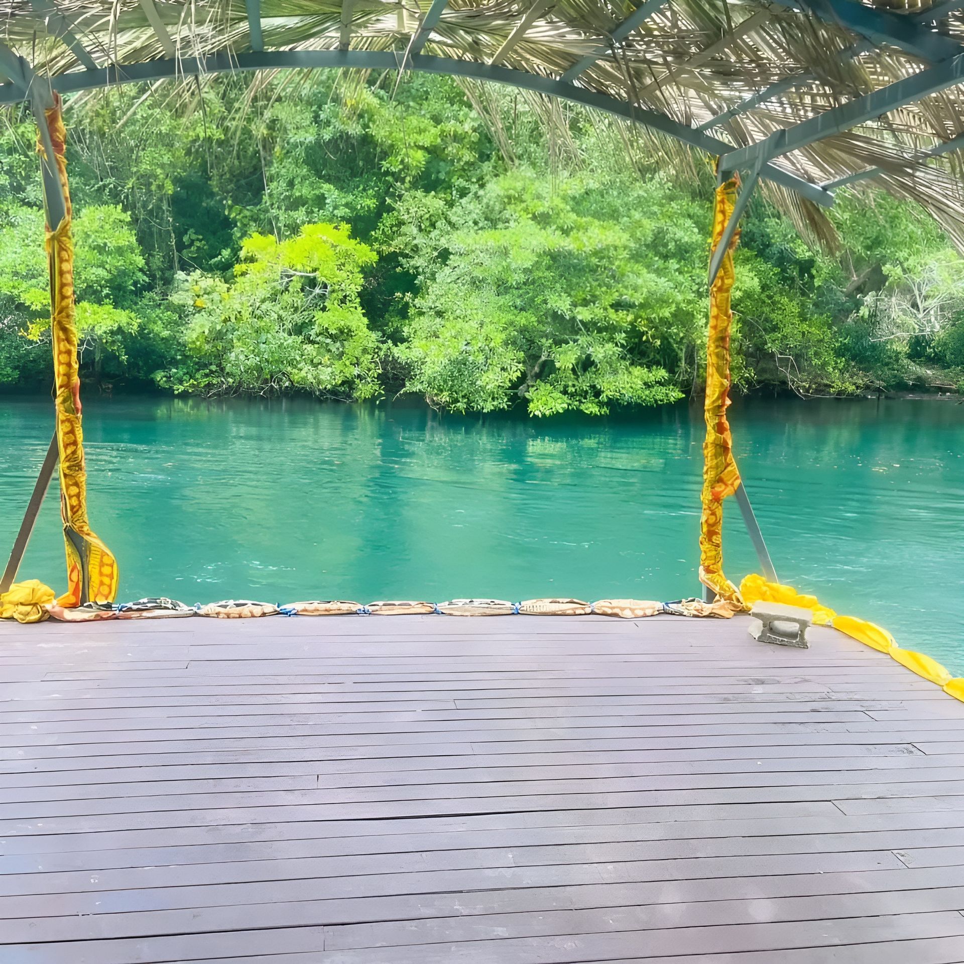 A wooden deck overlooking a body of water with trees in the background