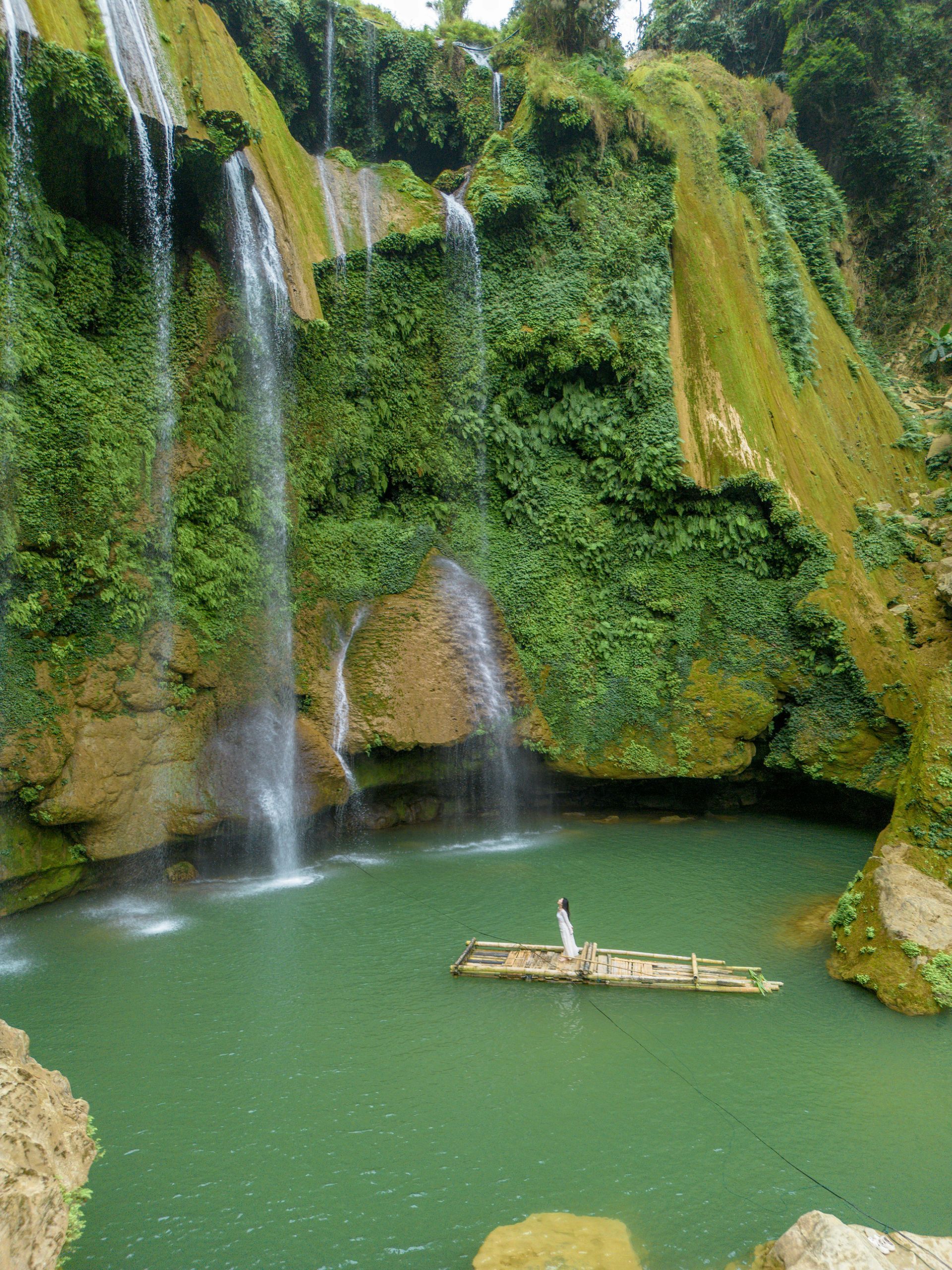 A waterfall with a boat in the middle of it