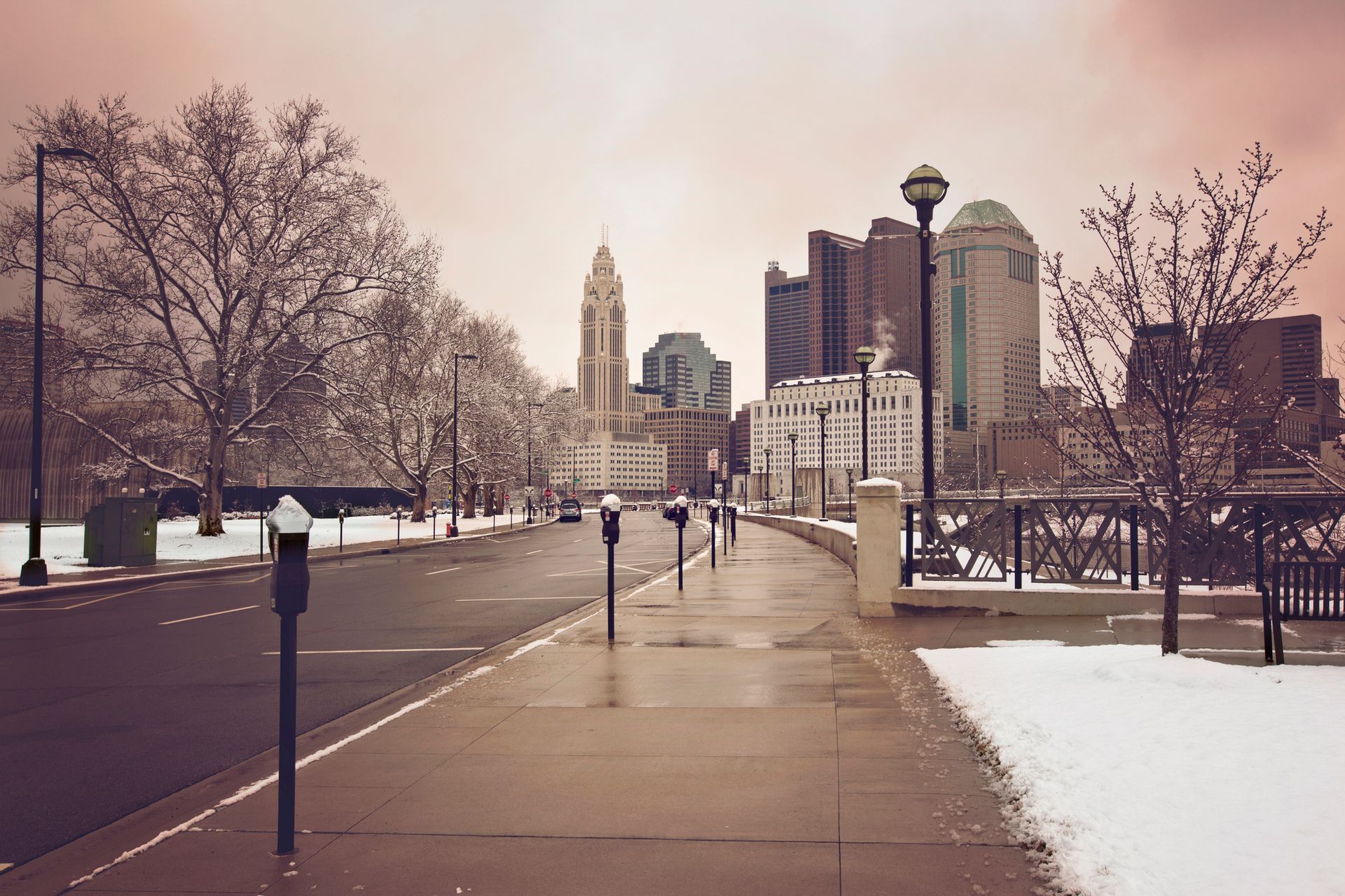 View of Columbus, Ohio from the sidewalk with snow on the ground.