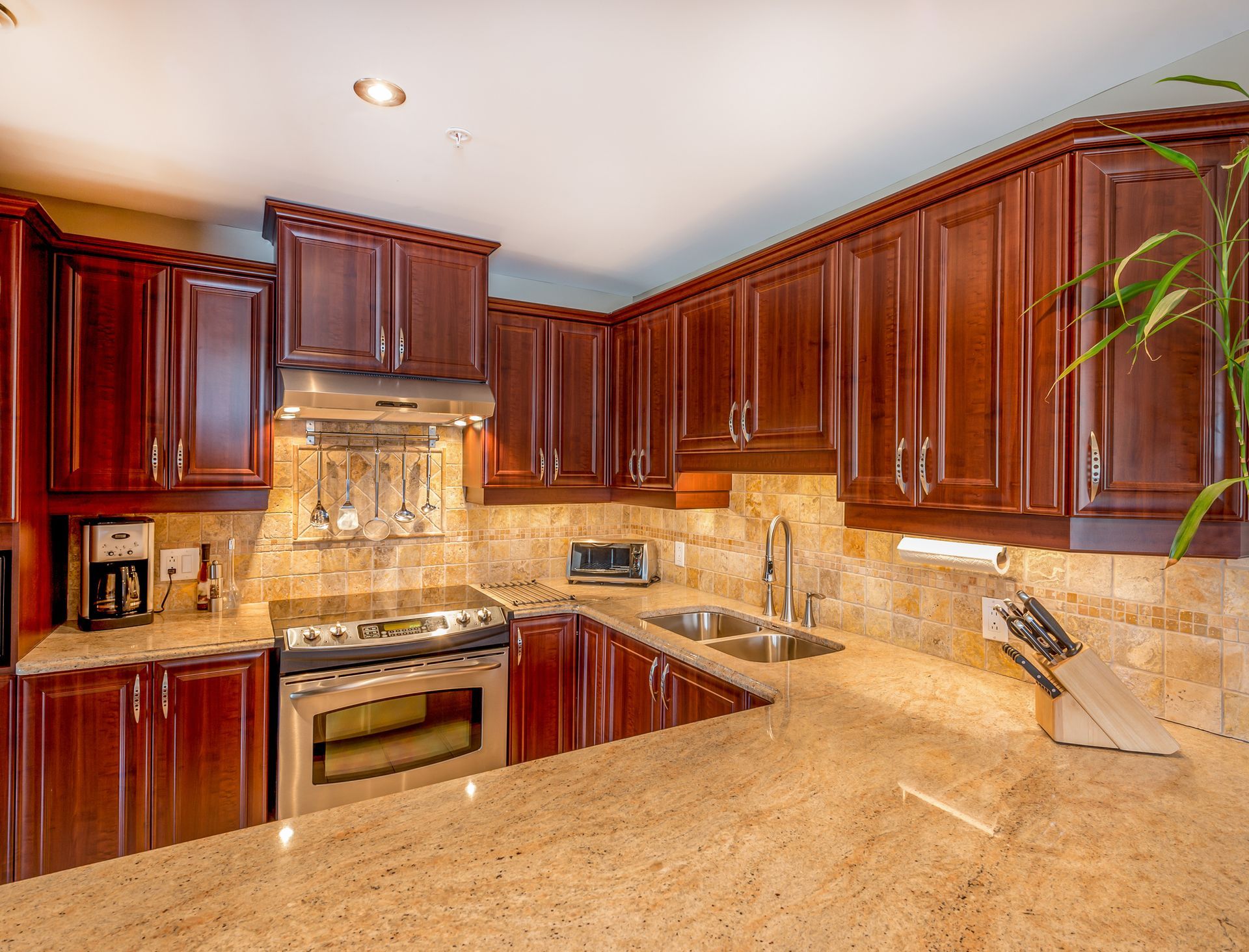 A kitchen with wooden cabinets and granite counter tops