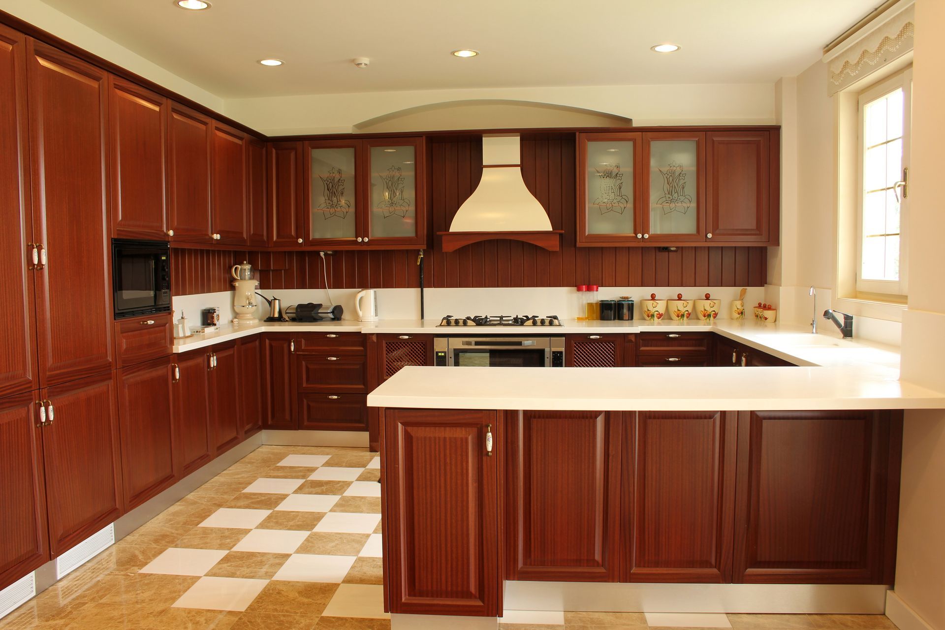 A kitchen with wooden cabinets and white counter tops