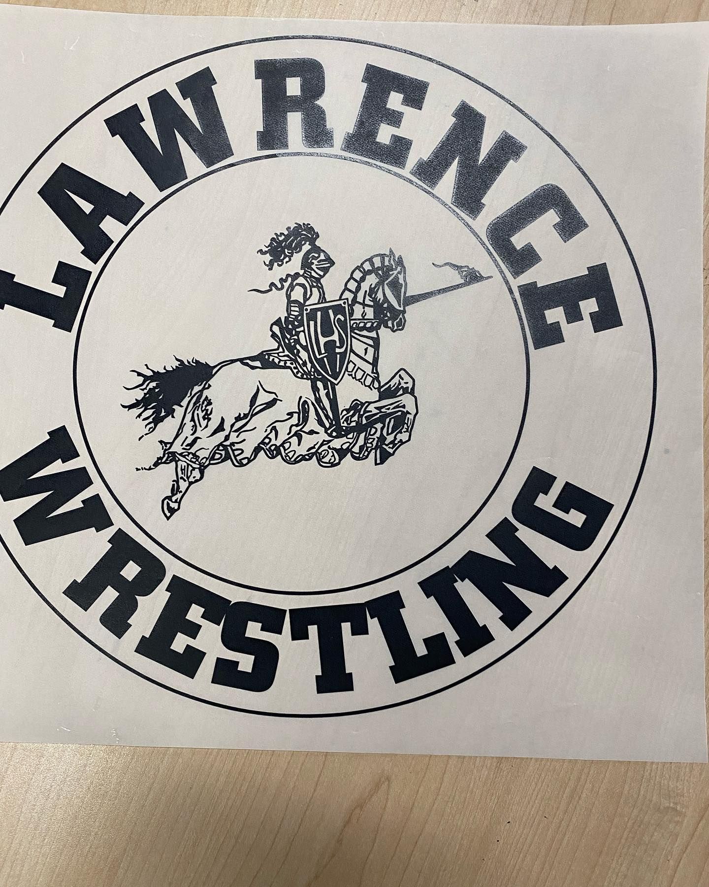 Lawrence Wrestling logo: a knight on horseback inside a circle, text 