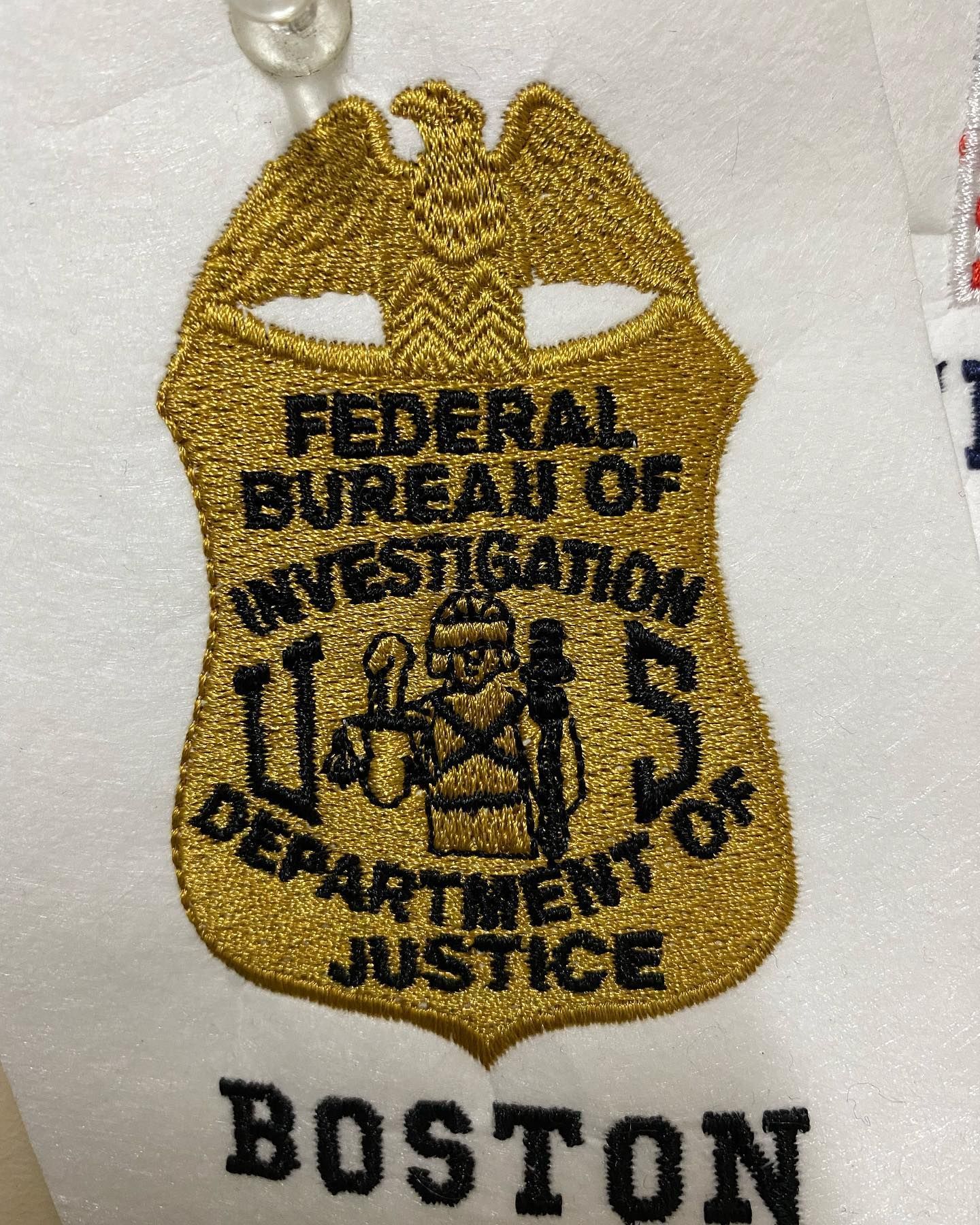 Embroidered FBI badge with gold outline, black text, and Boston below.