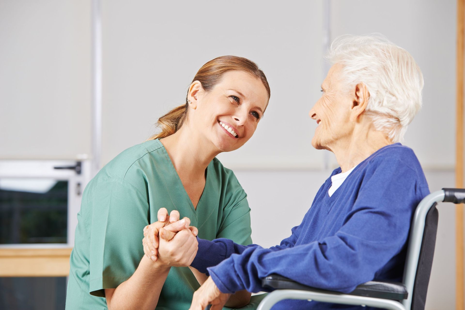 happy geriatric nurse holding hands senior