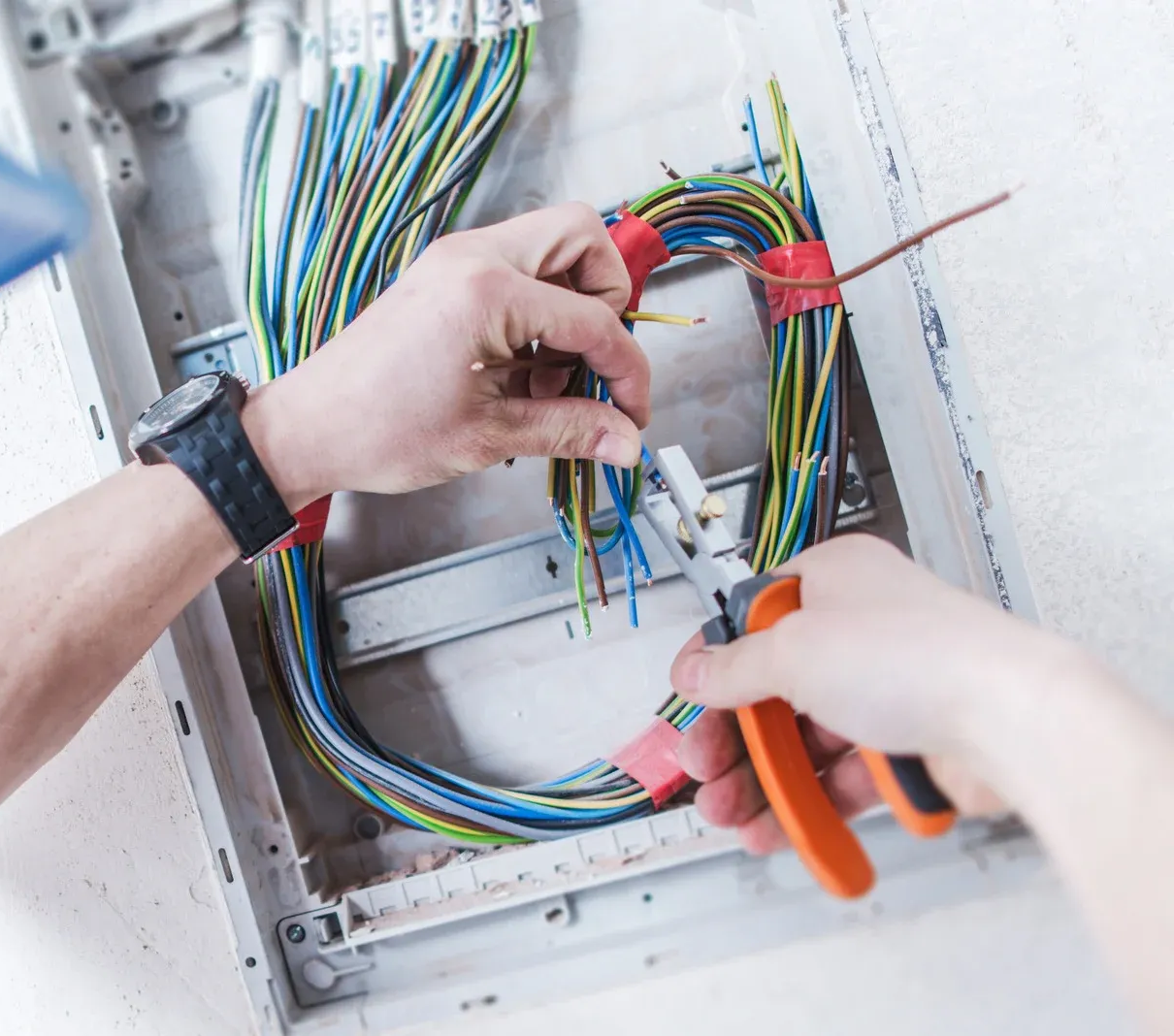 Person using a screwdriver to install or repair components inside a desktop computer case.