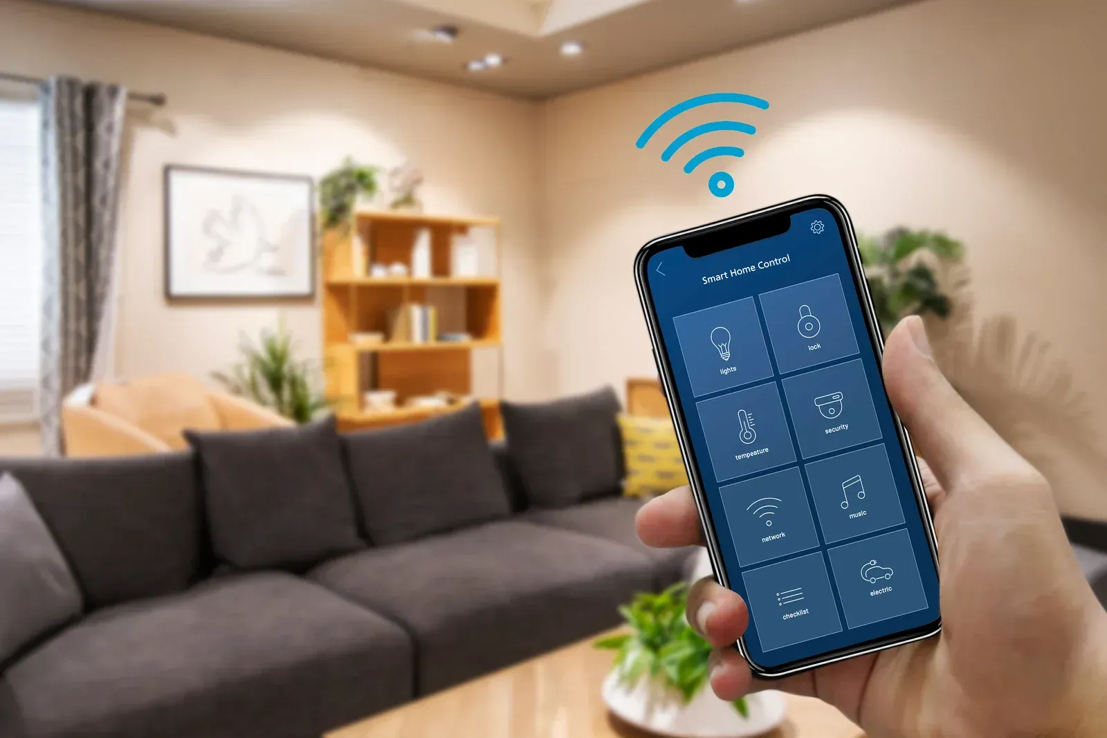 Hand holding phone with smart home app, controlling lights in a living room.