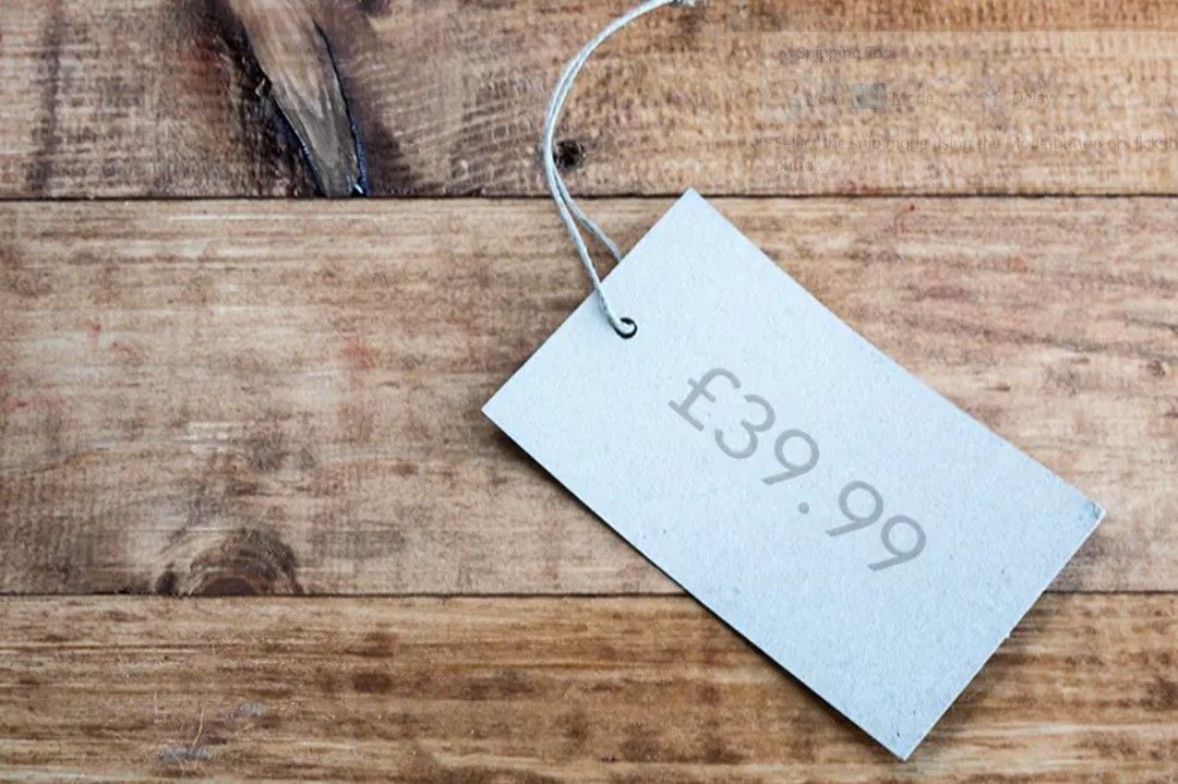 Odd Number pricing label sat on top of a wooden table top - odd vs even pricing psychology